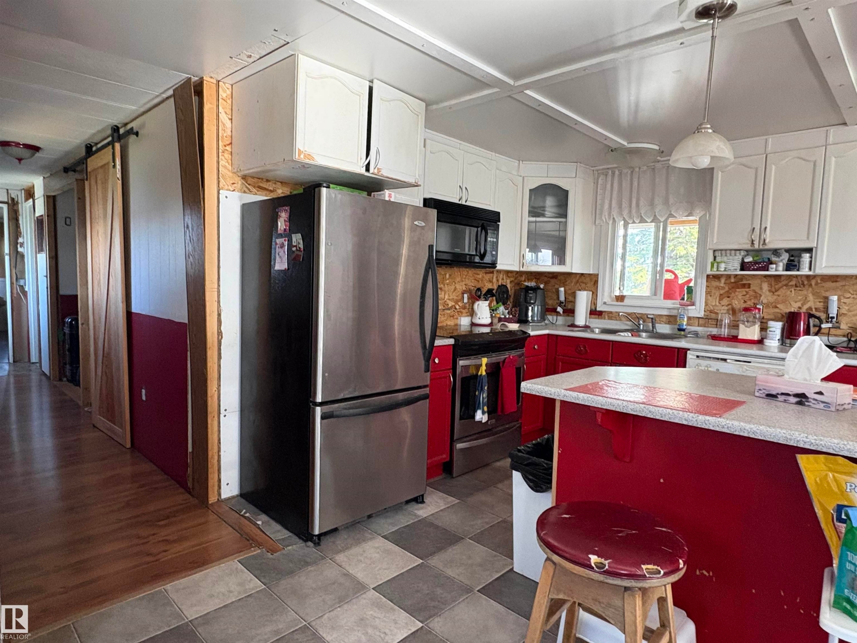 Kitchen featuring checkered tile flooring, white upper cabinetry, and red lower cabinetry. - 115 2Nd Street E, Derwent, AB - Indoor Photo Showing Kitchen With Double Sink