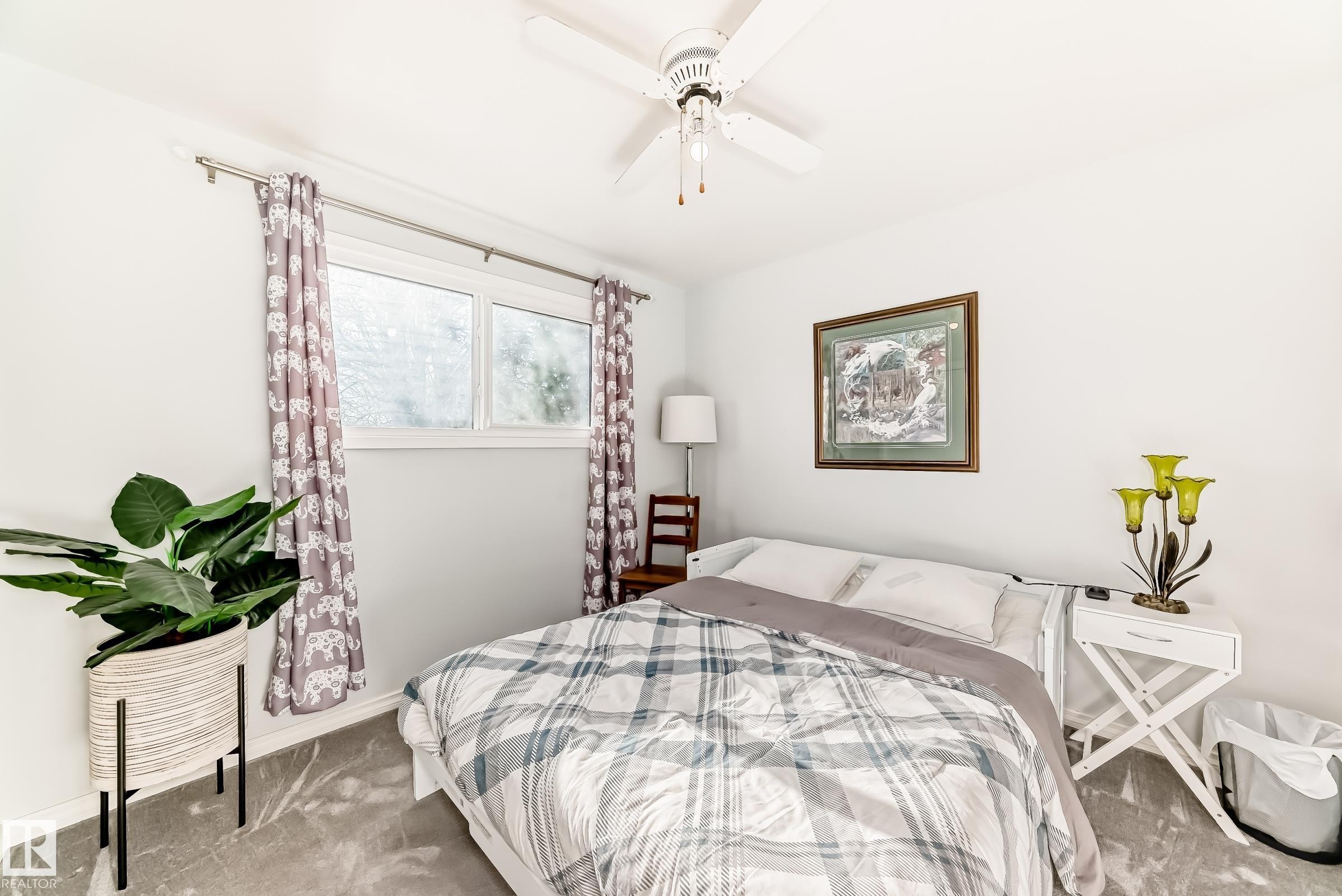 Light-filled room featuring a ceiling fan, two-pane window, and grey floor covering - 3611 108 Street, Edmonton, AB - Indoor Photo Showing Bedroom