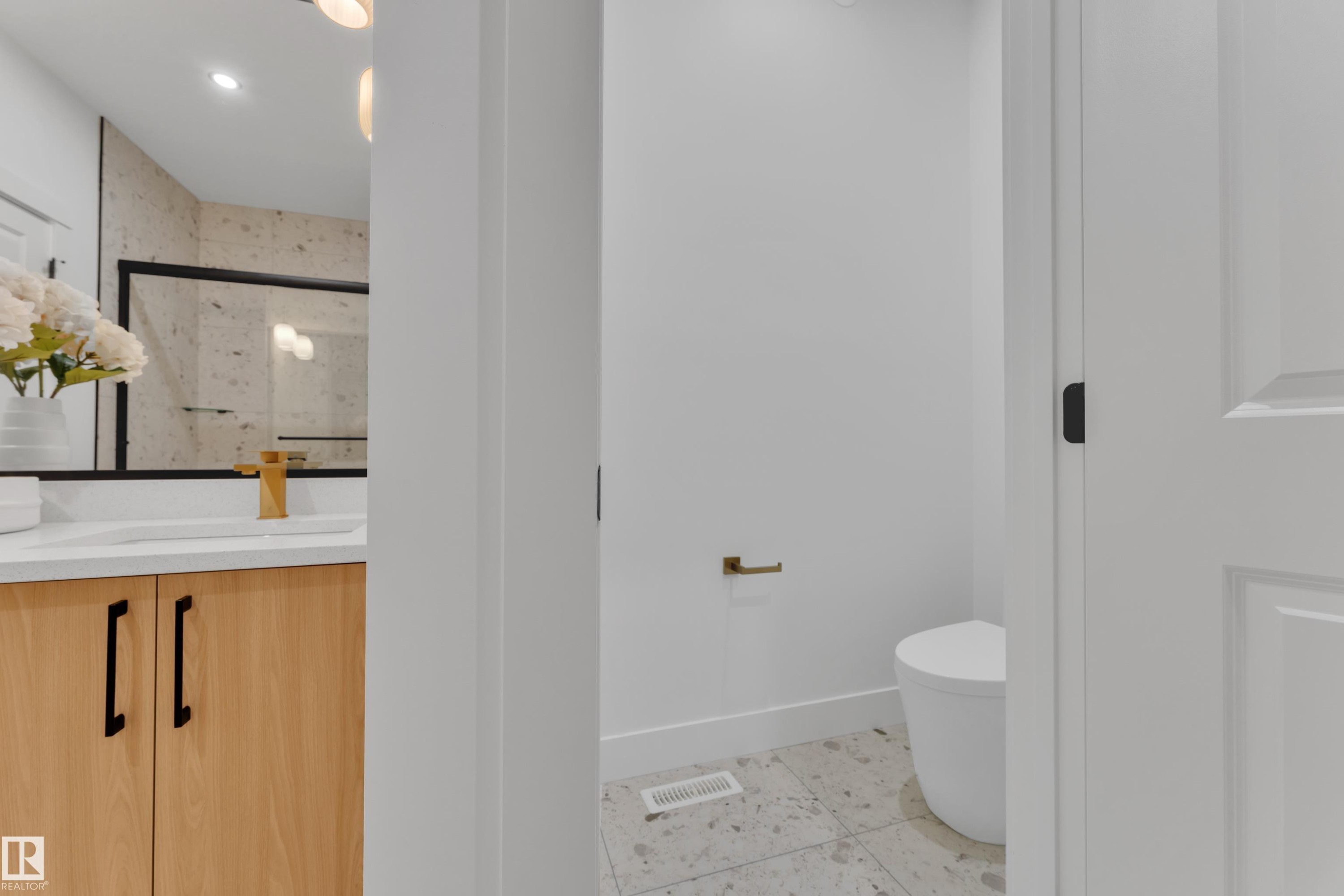 Bathroom featuring a wood-finish vanity with a white countertop, vessel sink, and gold-finish faucet - 382 Linden Loop, Leduc, AB - Indoor Photo Showing Other Room