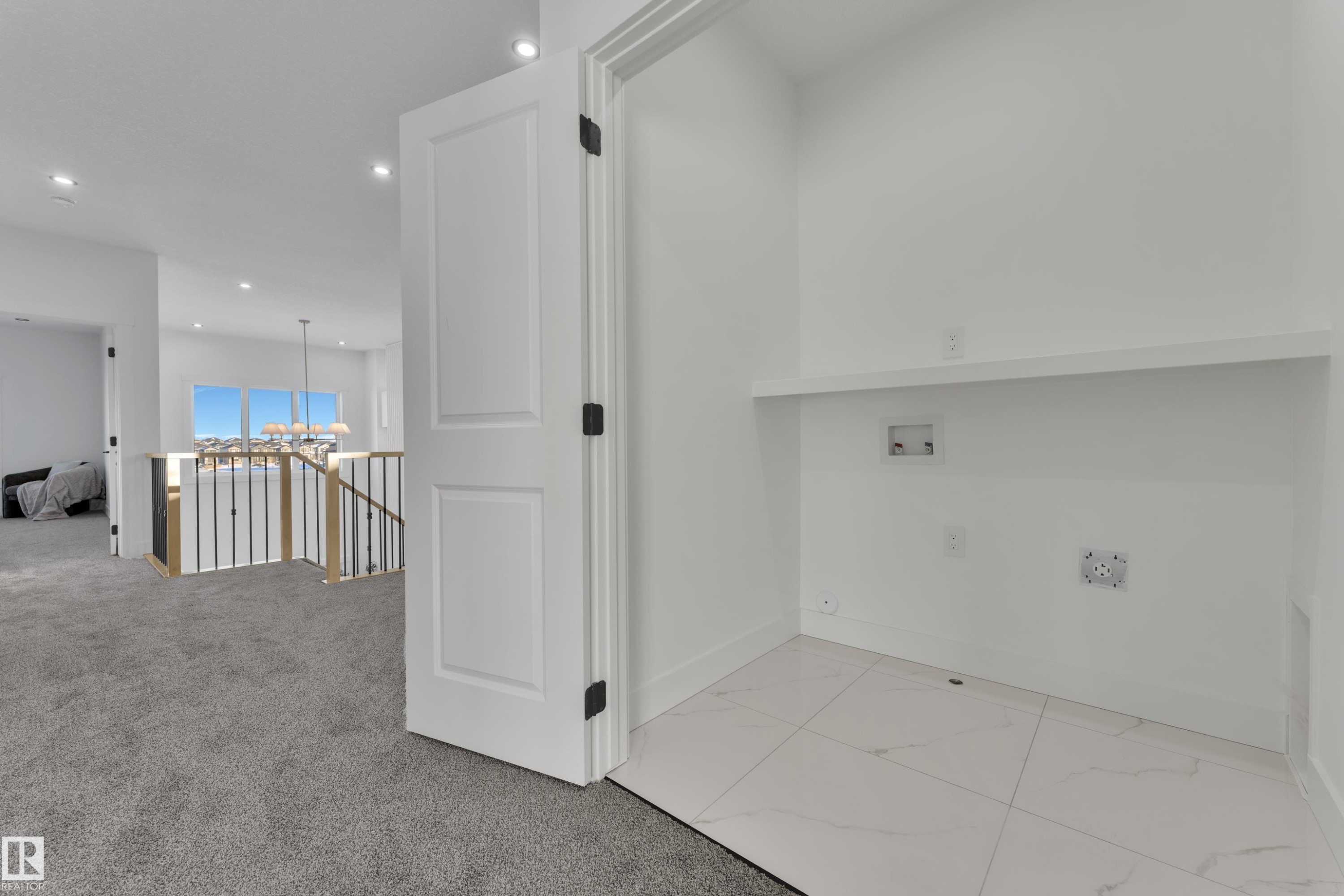 Dedicated laundry area featuring white tile flooring, a built-in shelf, and complete hookups for appliances - 382 Linden Loop, Leduc, AB - Indoor Photo Showing Other Room