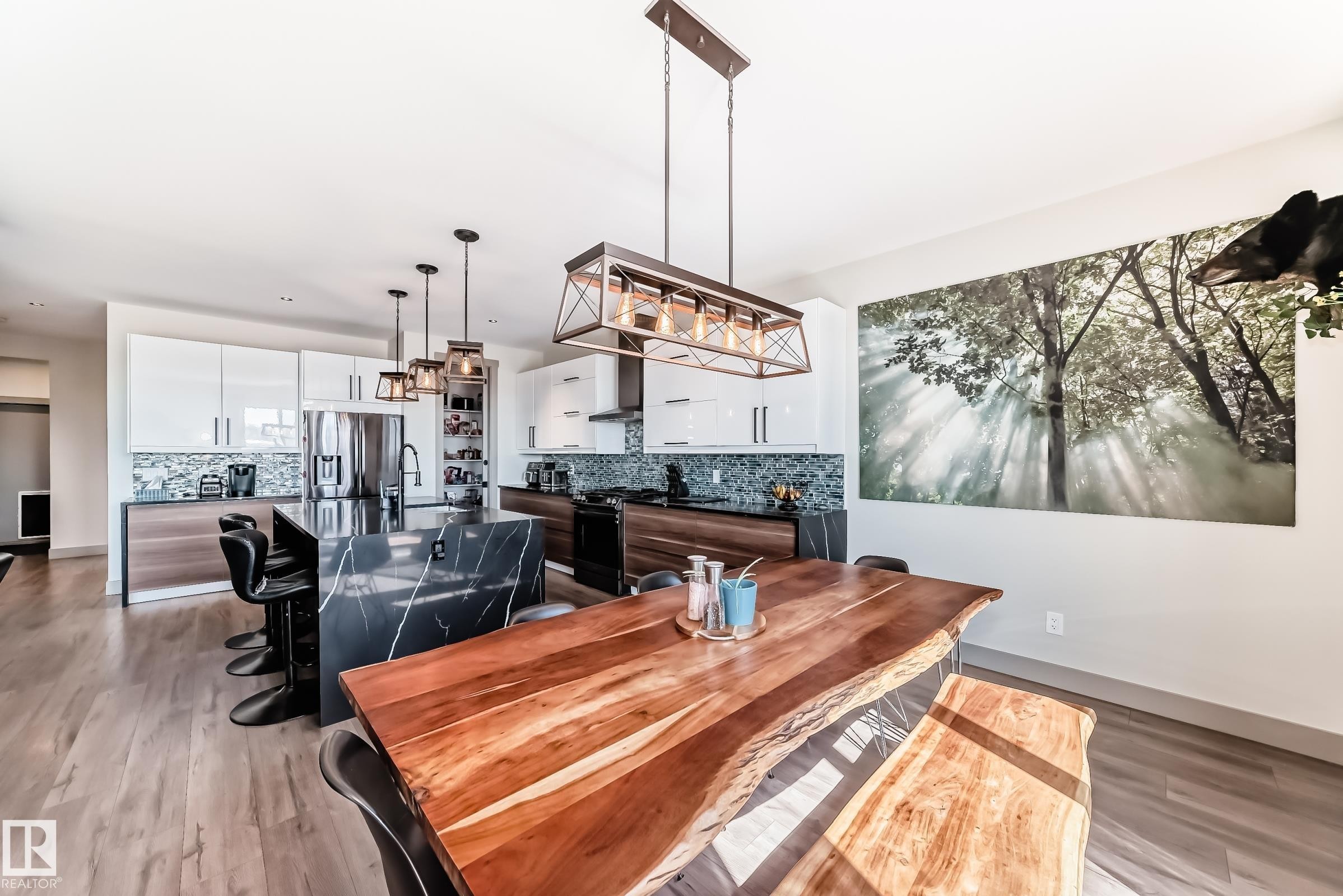 Modern kitchen and dining area featuring wood-finish flooring - 5263 47 Ave, Calmar, AB - Indoor Photo Showing Dining Room