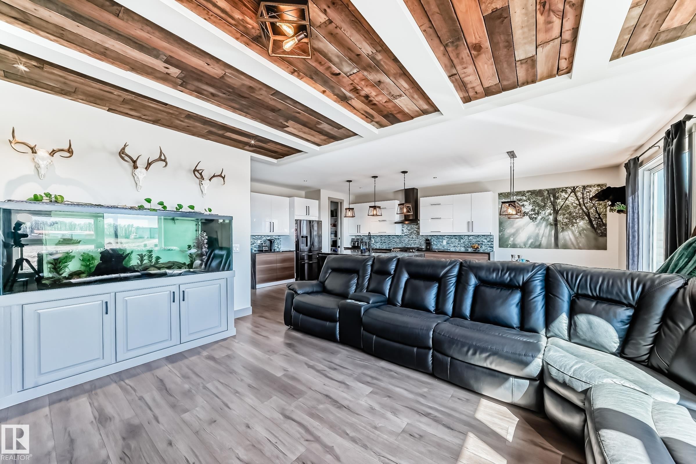 Open concept living space featuring wood-finish flooring and a decorative wood plank ceiling treatment - 5263 47 Ave, Calmar, AB - Indoor Photo Showing Living Room