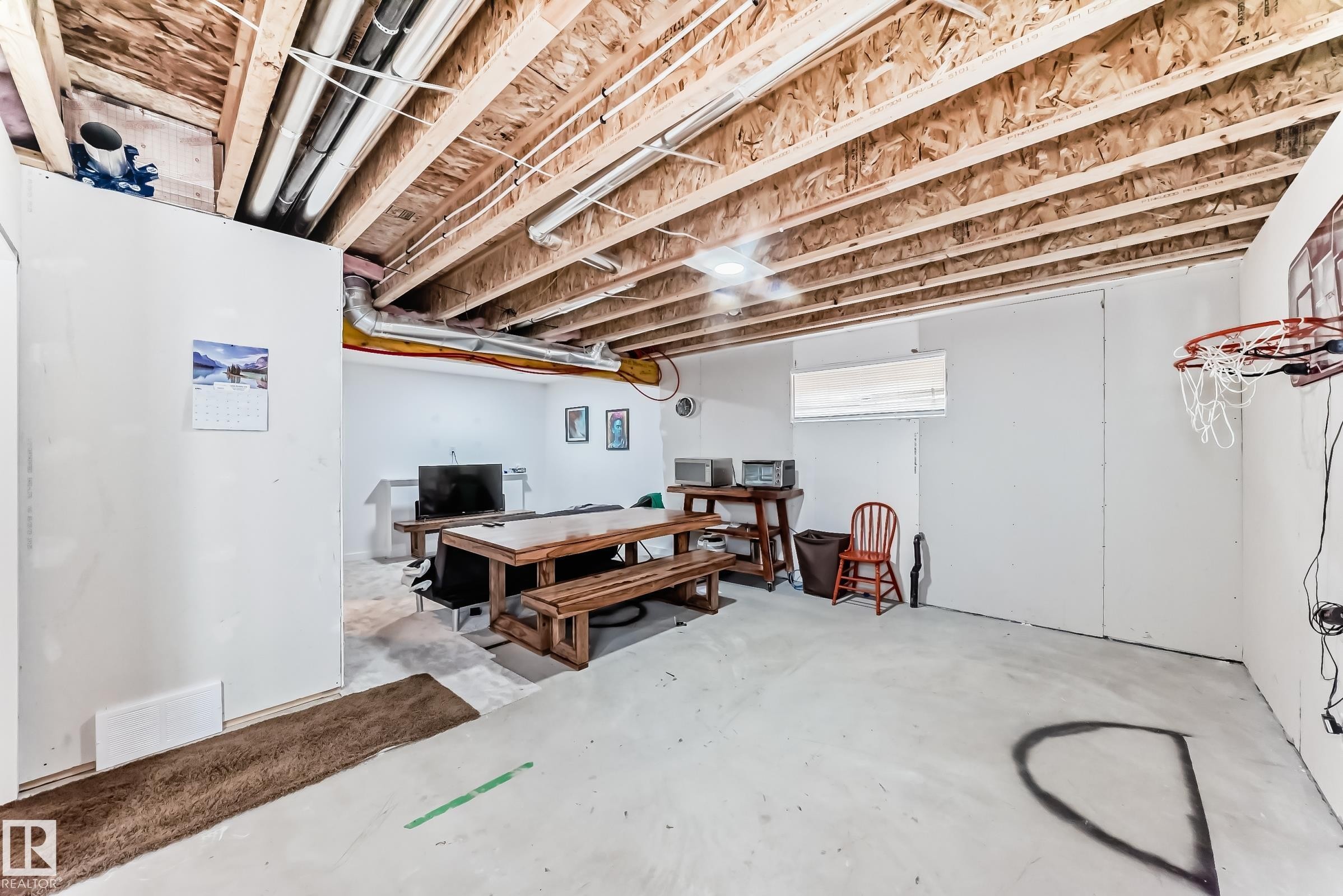 Unfinished basement space featuring exposed wood joists and visible utility lines - 5263 47 Ave, Calmar, AB - Indoor Photo Showing Basement