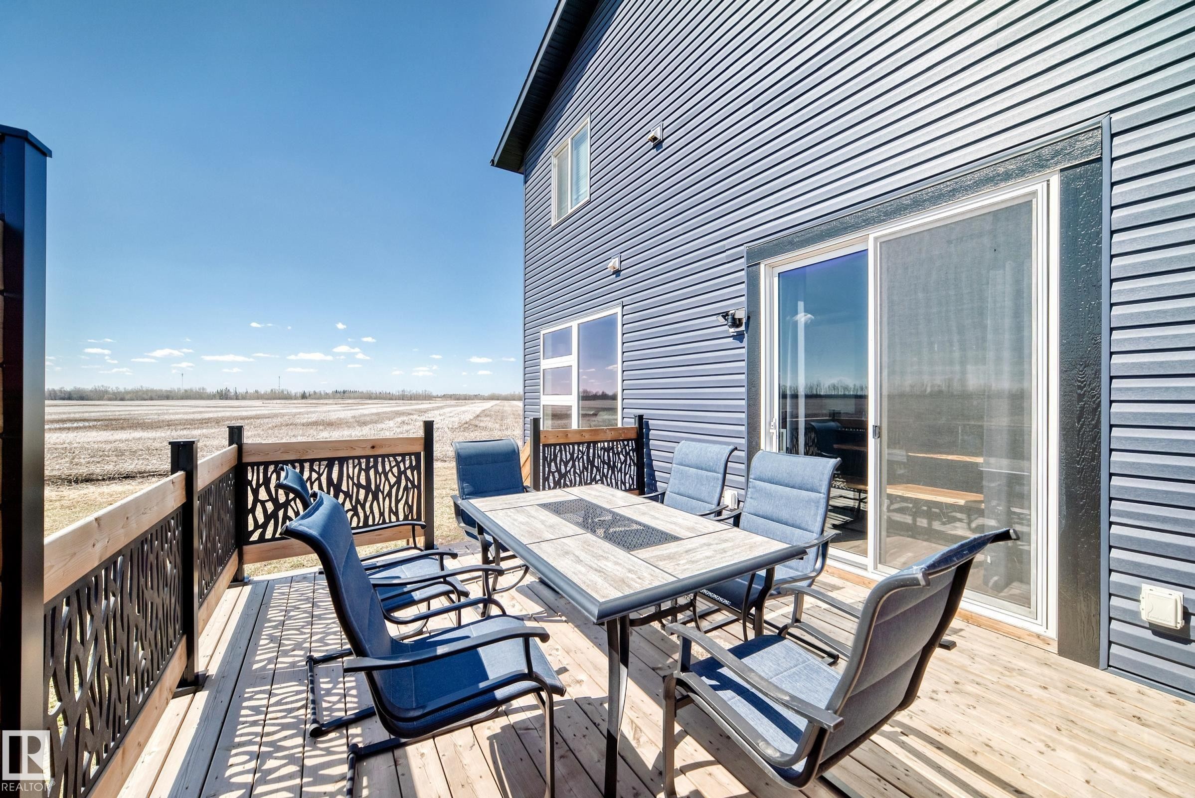 Wood-finish deck with decorative metal railing panels - 5263 47 Ave, Calmar, AB - Outdoor With Deck Patio Veranda With Exterior
