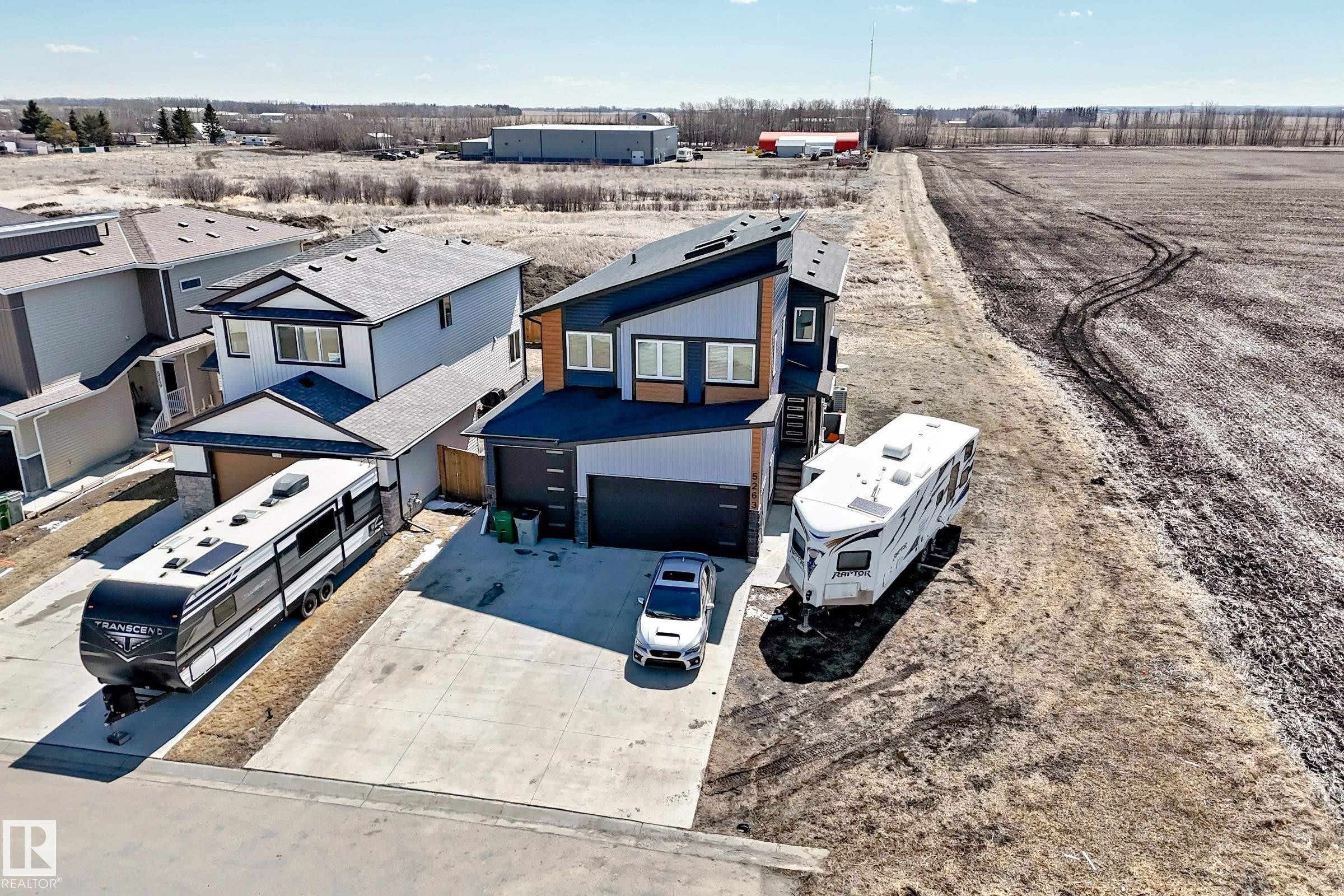 Modern two-story residence featuring a striking multi-toned exterior with dark and light siding accents - 5263 47 Ave, Calmar, AB - Outdoor