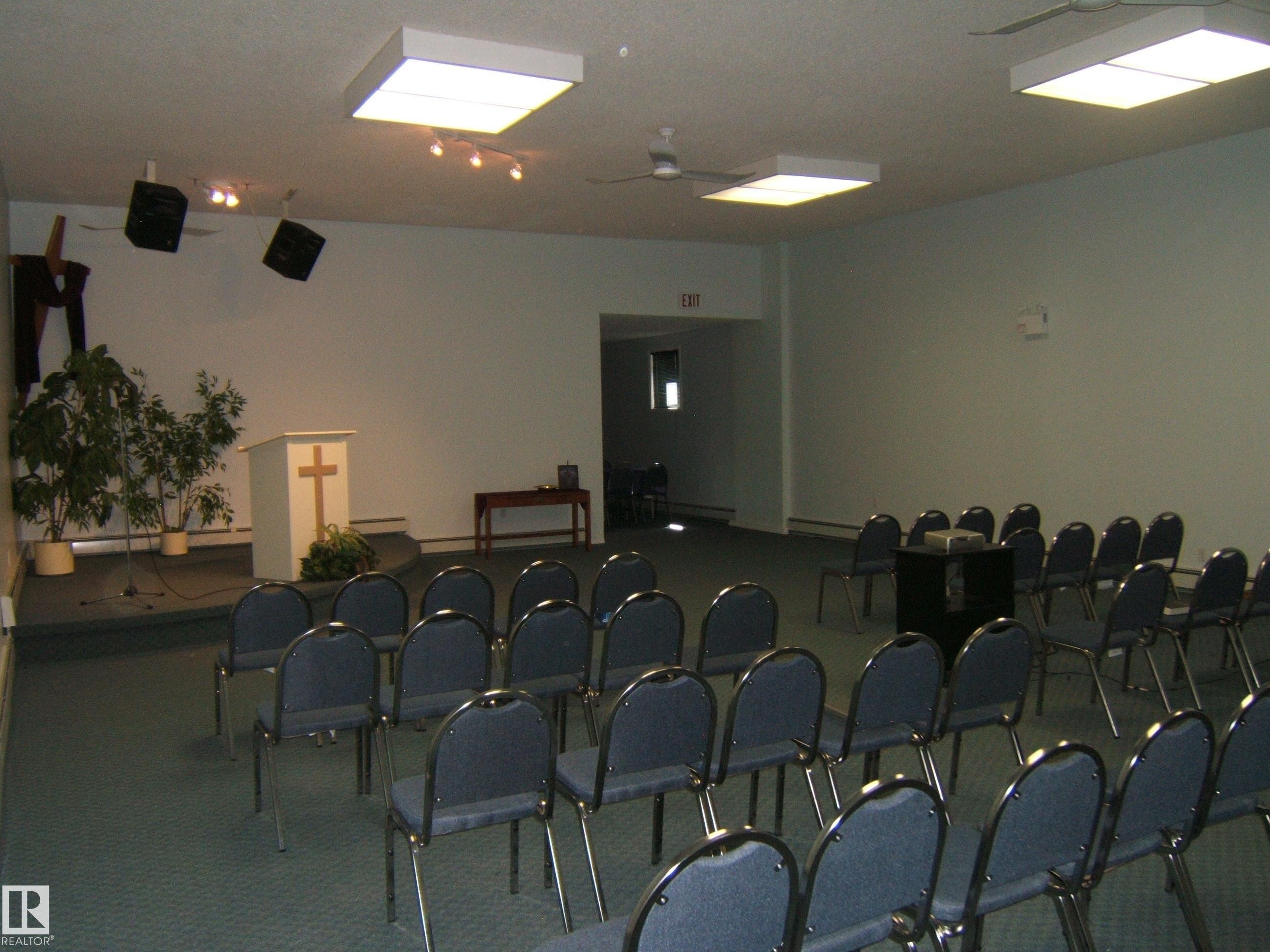 Spacious interior featuring a raised platform area, recessed ceiling lighting, and overhead ceiling fans - 4707 50 Street, Two Hills, AB - Indoor Photo Showing Other Room