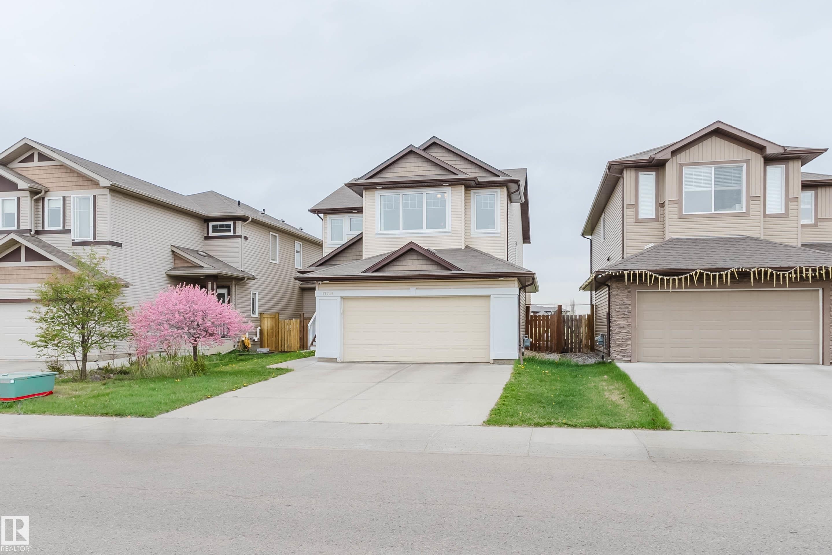 Two-story residence featuring light-colored siding with contrasting brown trim accents and a concrete driveway - 17718 5A Avenue, Edmonton, AB - Outdoor With Facade