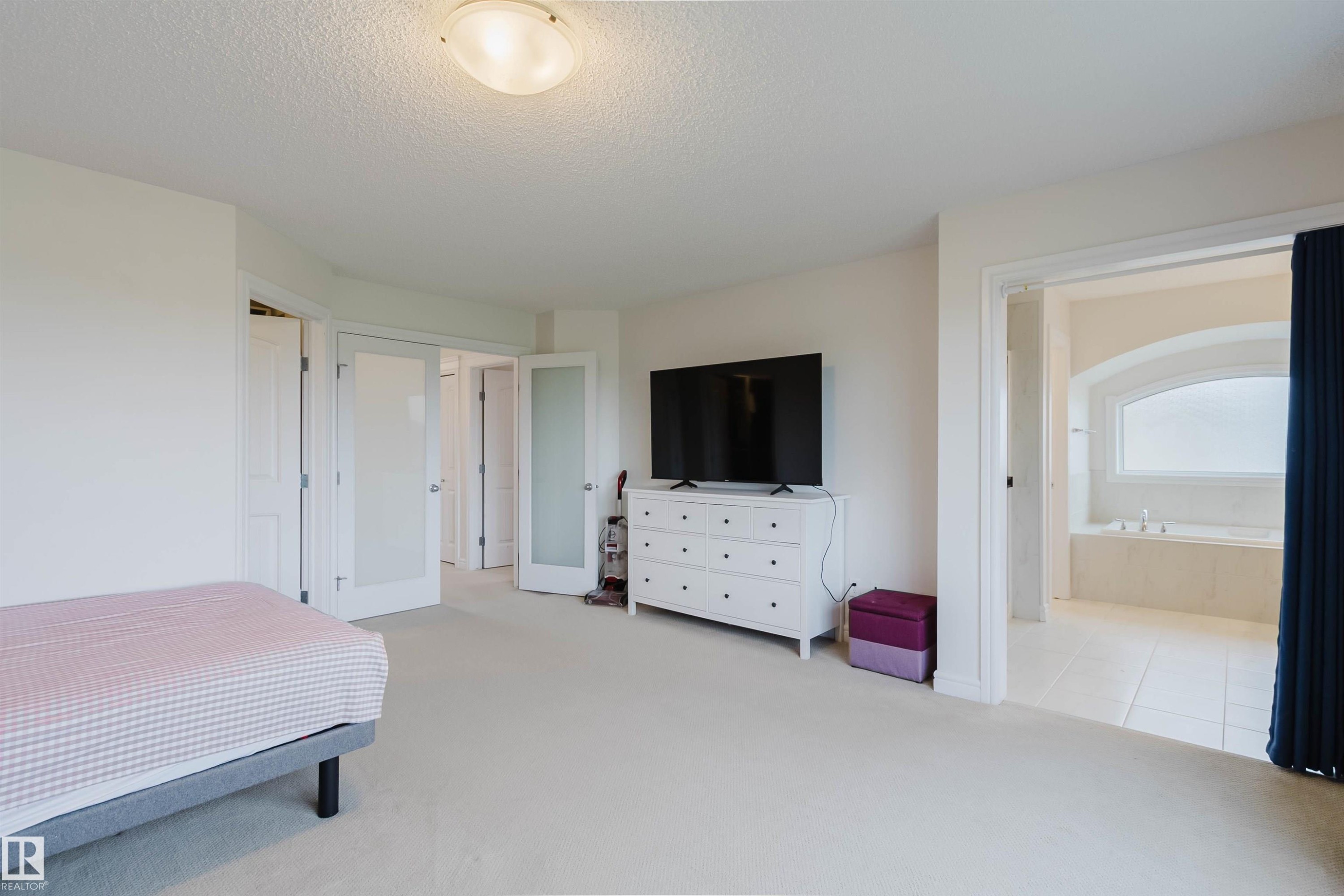 Carpeted bedroom with a built-in ceiling light fixture - 17718 5A Avenue, Edmonton, AB - Indoor Photo Showing Bedroom
