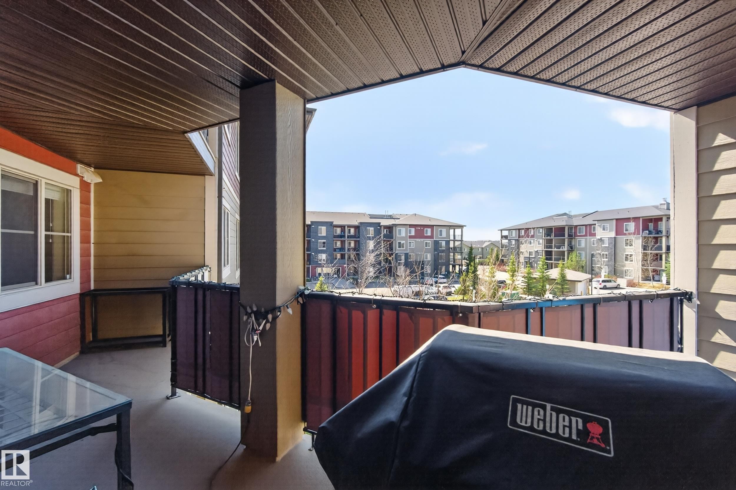 Covered balcony featuring a textured ceiling, a concrete floor, and painted siding - 314 3211 James Mowatt Trail Sw, Edmonton, AB - Outdoor With Deck Patio Veranda With Exterior
