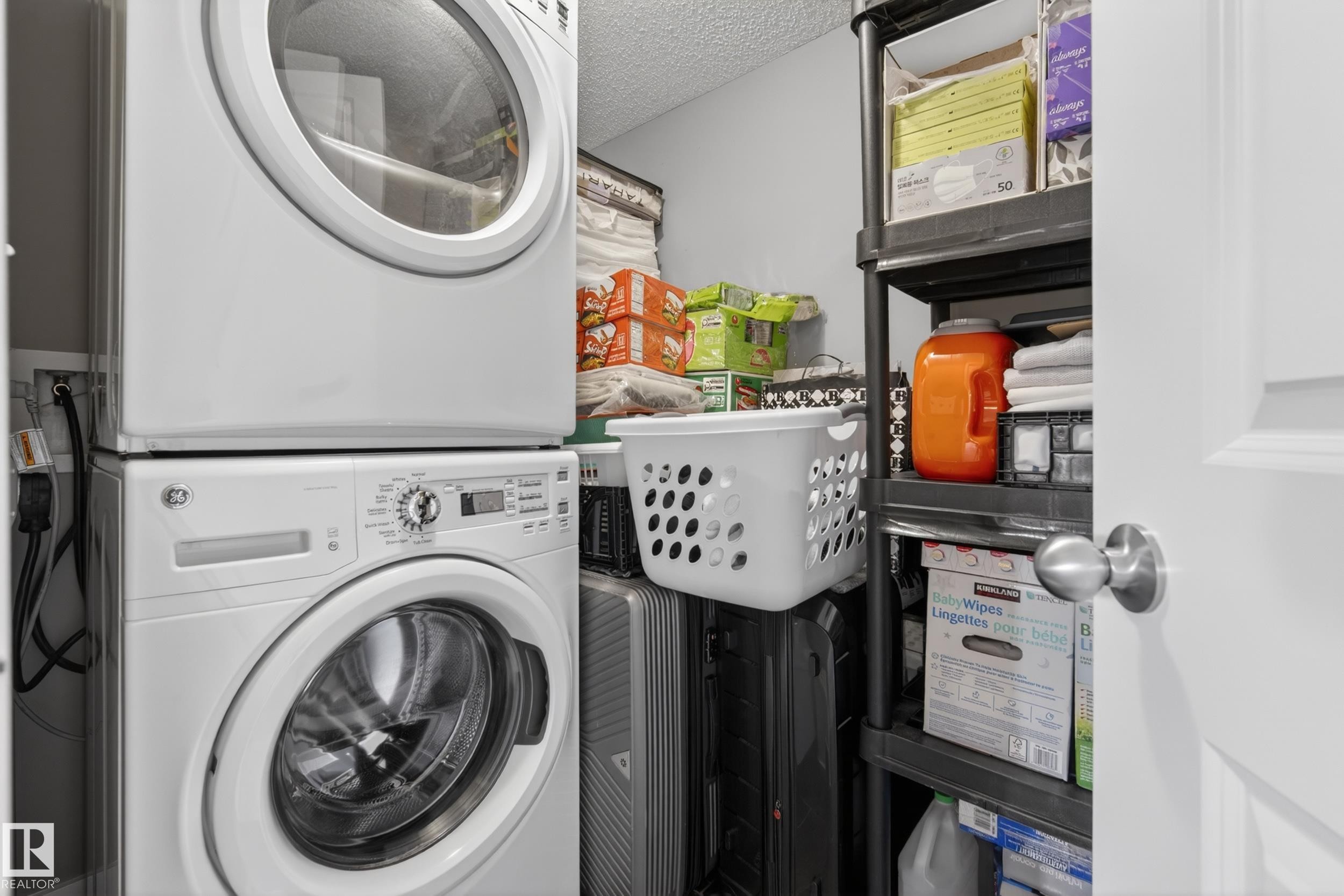 Dedicated utility space featuring a stacked washer and dryer unit - 314 3211 James Mowatt Trail Sw, Edmonton, AB - Indoor Photo Showing Laundry Room