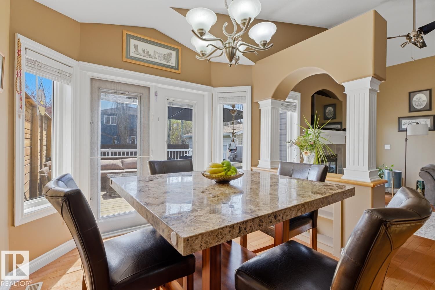 Dining area featuring a bay window, glass-panel door to an exterior deck, vaulted ceiling, and a chandelier - 9 Danfield Place, Spruce Grove, AB - Indoor Photo Showing Dining Room
