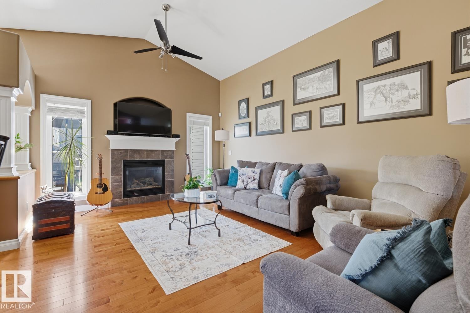 Living area featuring vaulted ceilings, a ceiling fan, and hardwood flooring - 9 Danfield Place, Spruce Grove, AB - Indoor Photo Showing Living Room With Fireplace