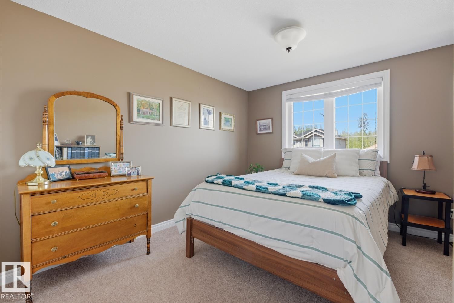 Bedroom featuring light brown wall paint and neutral-toned carpet flooring - 9 Danfield Place, Spruce Grove, AB - Indoor Photo Showing Bedroom