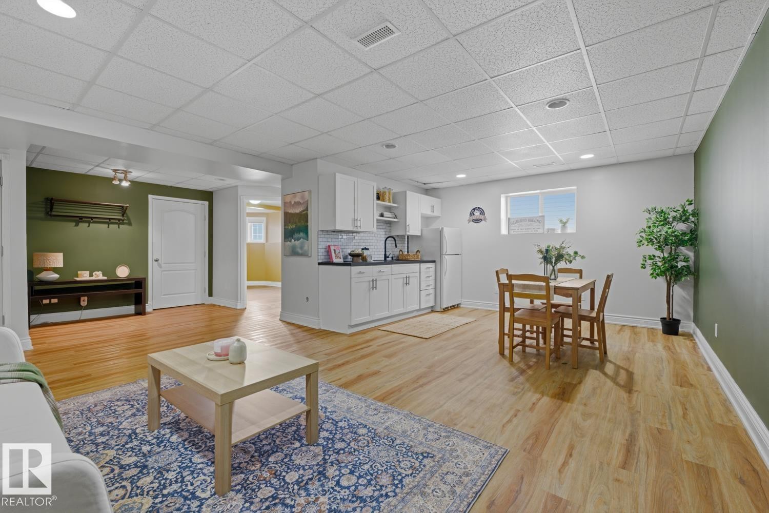 Open-concept lower level featuring wood-finish flooring, recessed lighting, and a drop ceiling - 9 Danfield Place, Spruce Grove, AB - Indoor Photo Showing Living Room