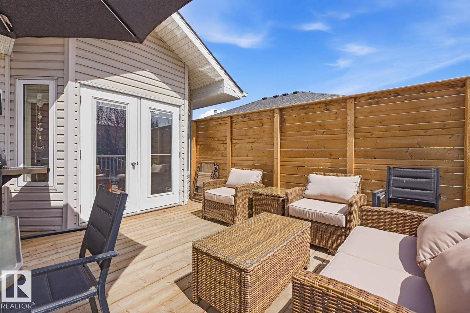 Expansive wood-finish deck featuring double glass panel doors - 9 Danfield Place, Spruce Grove, AB - Outdoor With Deck Patio Veranda With Exterior
