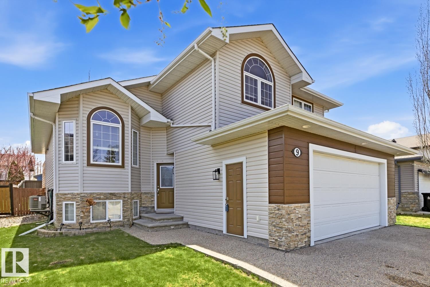 Contemporary exterior featuring light-toned horizontal siding with contrasting brown accents - 9 Danfield Place, Spruce Grove, AB - Outdoor