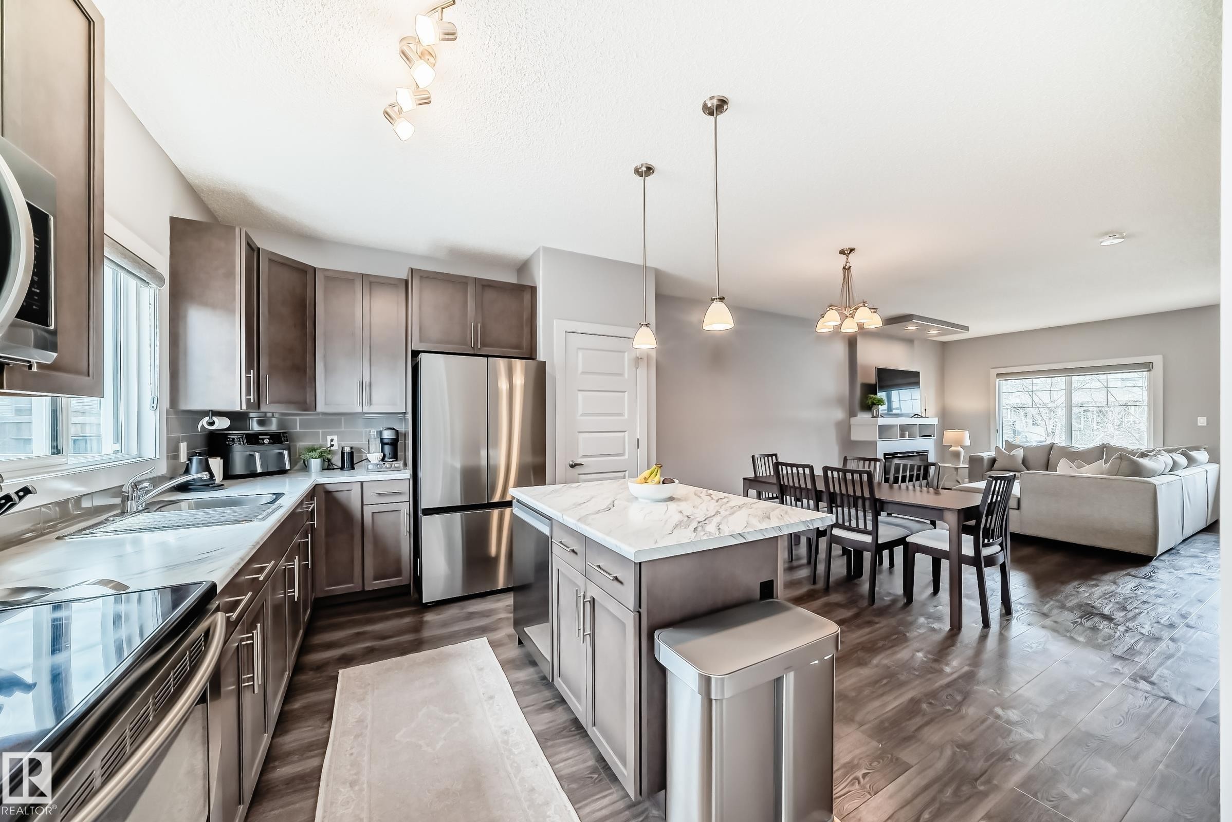 Kitchen featuring an island , stainless steel appliances, wood-finish flooring, and recessed lighting - 6919 Cardinal Wynd, Edmonton, AB - Indoor Photo Showing Kitchen With Stainless Steel Kitchen With Double Sink With Upgraded Kitchen