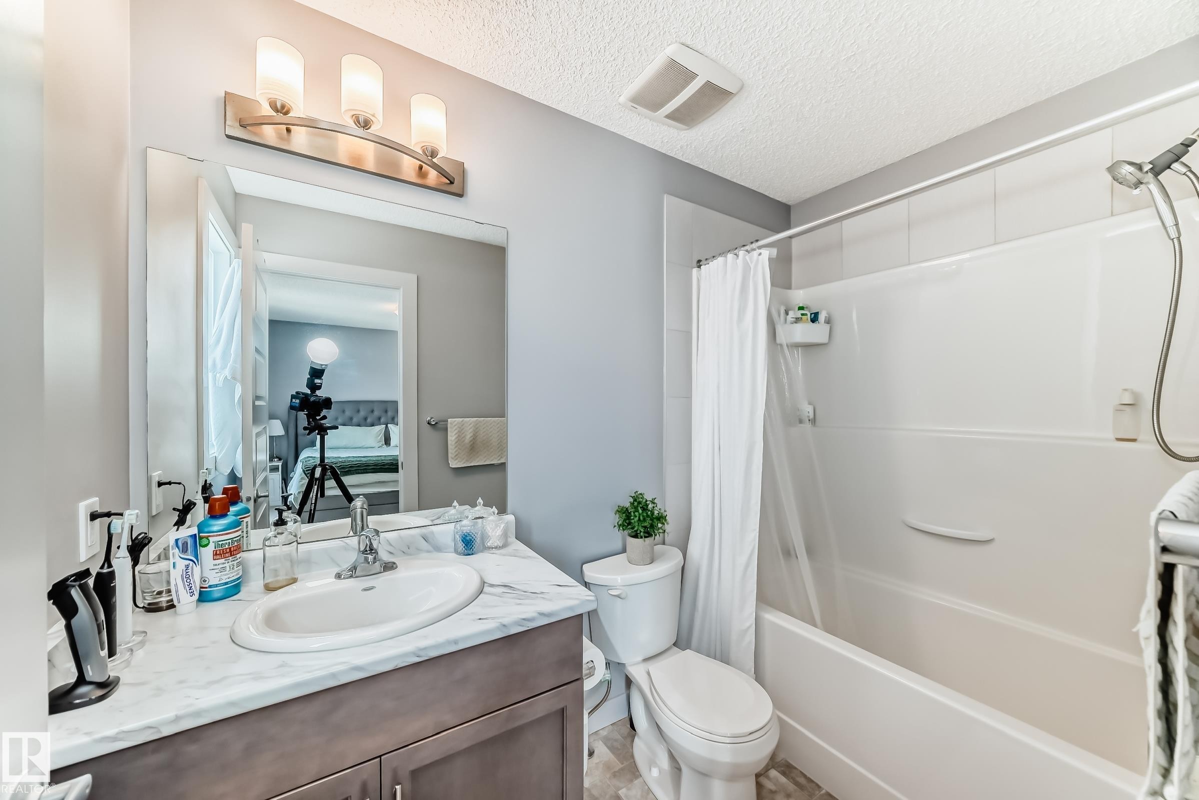 Bathroom featuring a vanity with an integrated sink, a white countertop, and under-sink cabinetry - 6919 Cardinal Wynd, Edmonton, AB - Indoor Photo Showing Bathroom