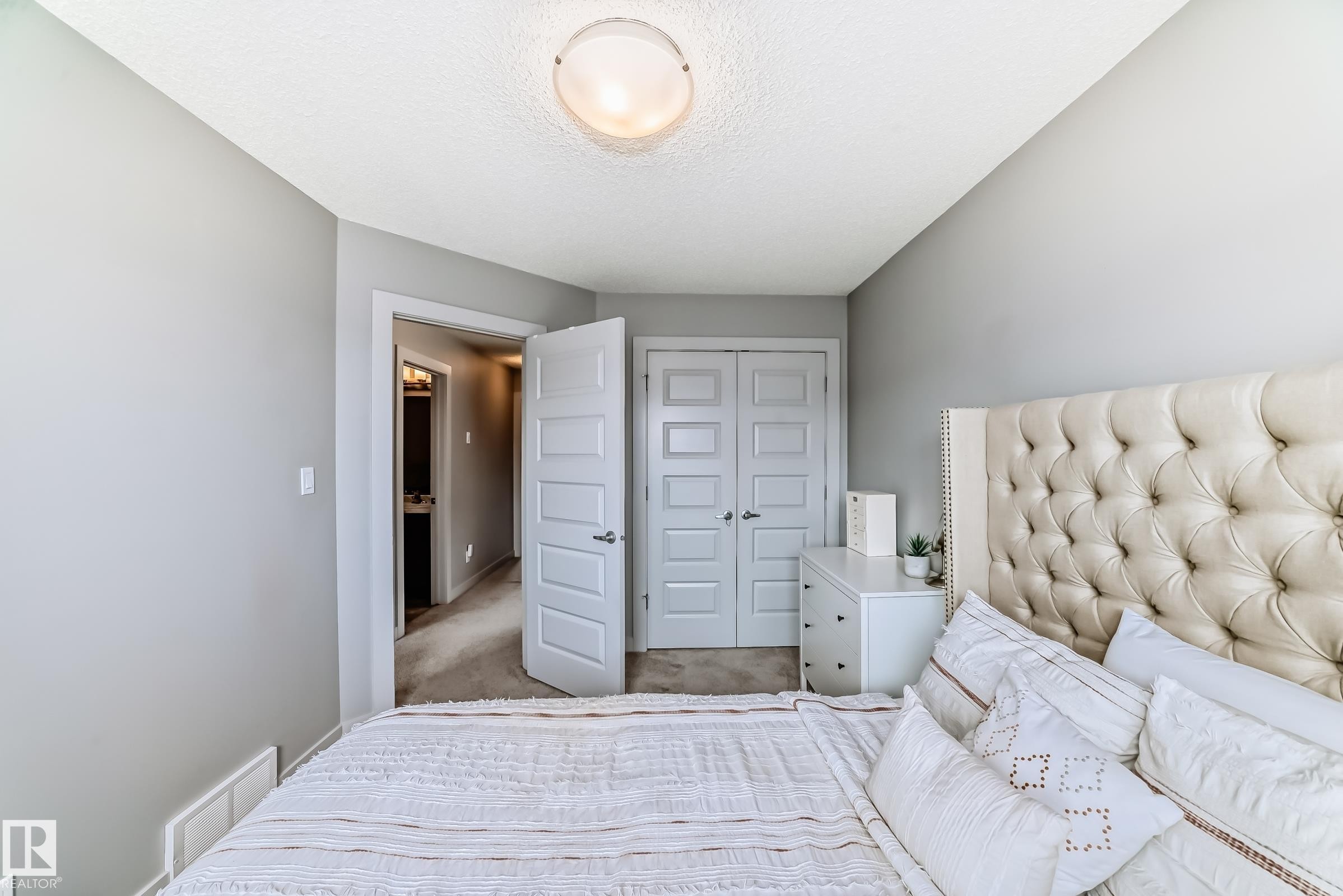 Carpeted room with light grey walls and a textured ceiling - 6919 Cardinal Wynd, Edmonton, AB - Indoor Photo Showing Bedroom