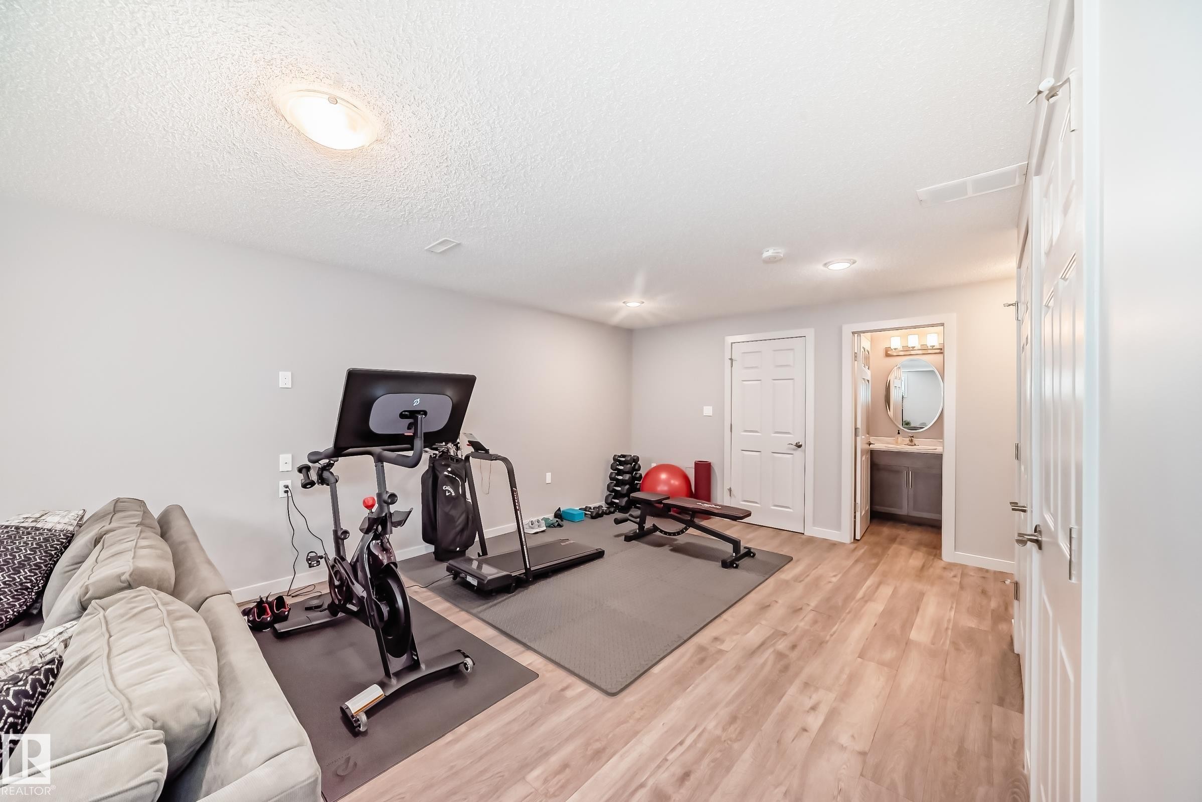 Versatile finished room featuring wood-finish flooring, recessed lighting, and a neutral color palette - 6919 Cardinal Wynd, Edmonton, AB - Indoor Photo Showing Gym Room