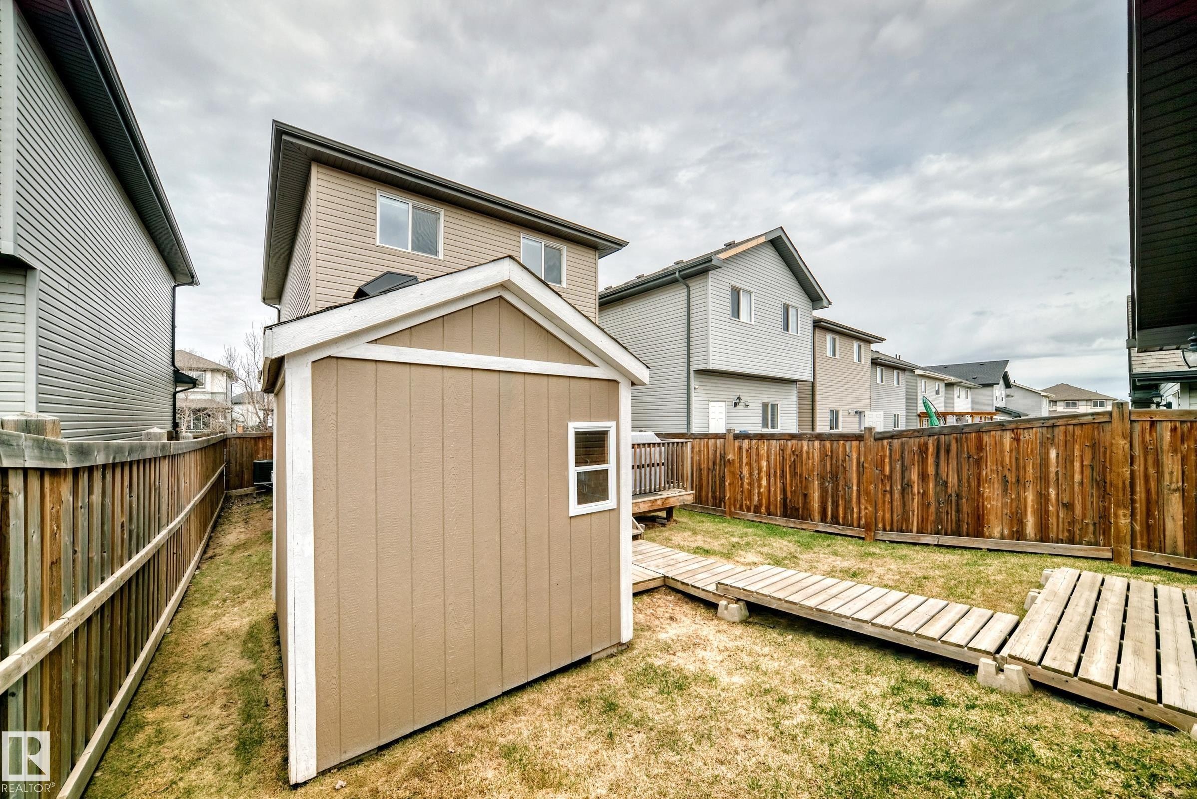 Backyard featuring 2 sheds - 6919 Cardinal Wynd, Edmonton, AB - Outdoor With Exterior