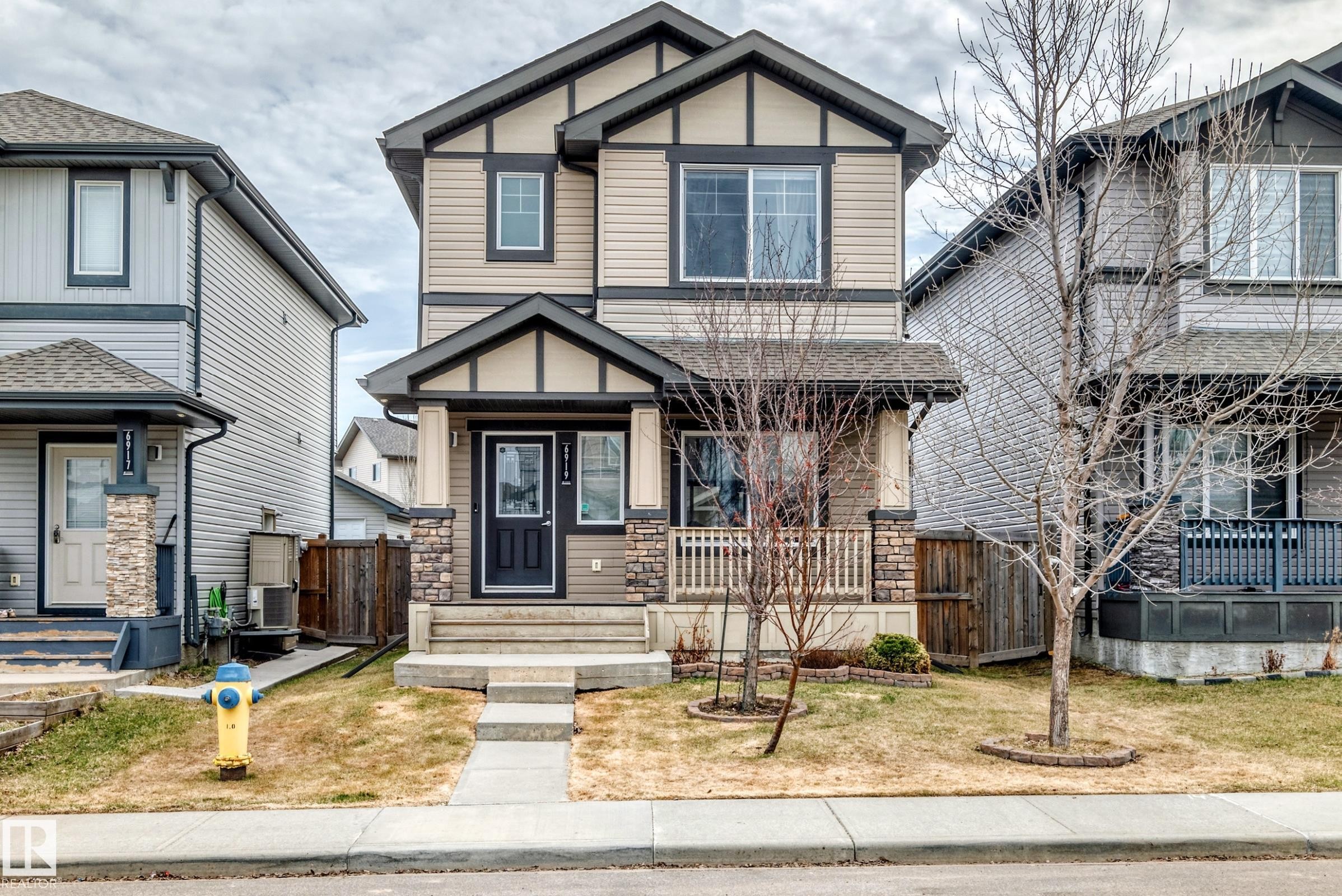 Two-story home featuring a combination of horizontal siding and stone accents on the facade - 6919 Cardinal Wynd, Edmonton, AB - Outdoor With Facade