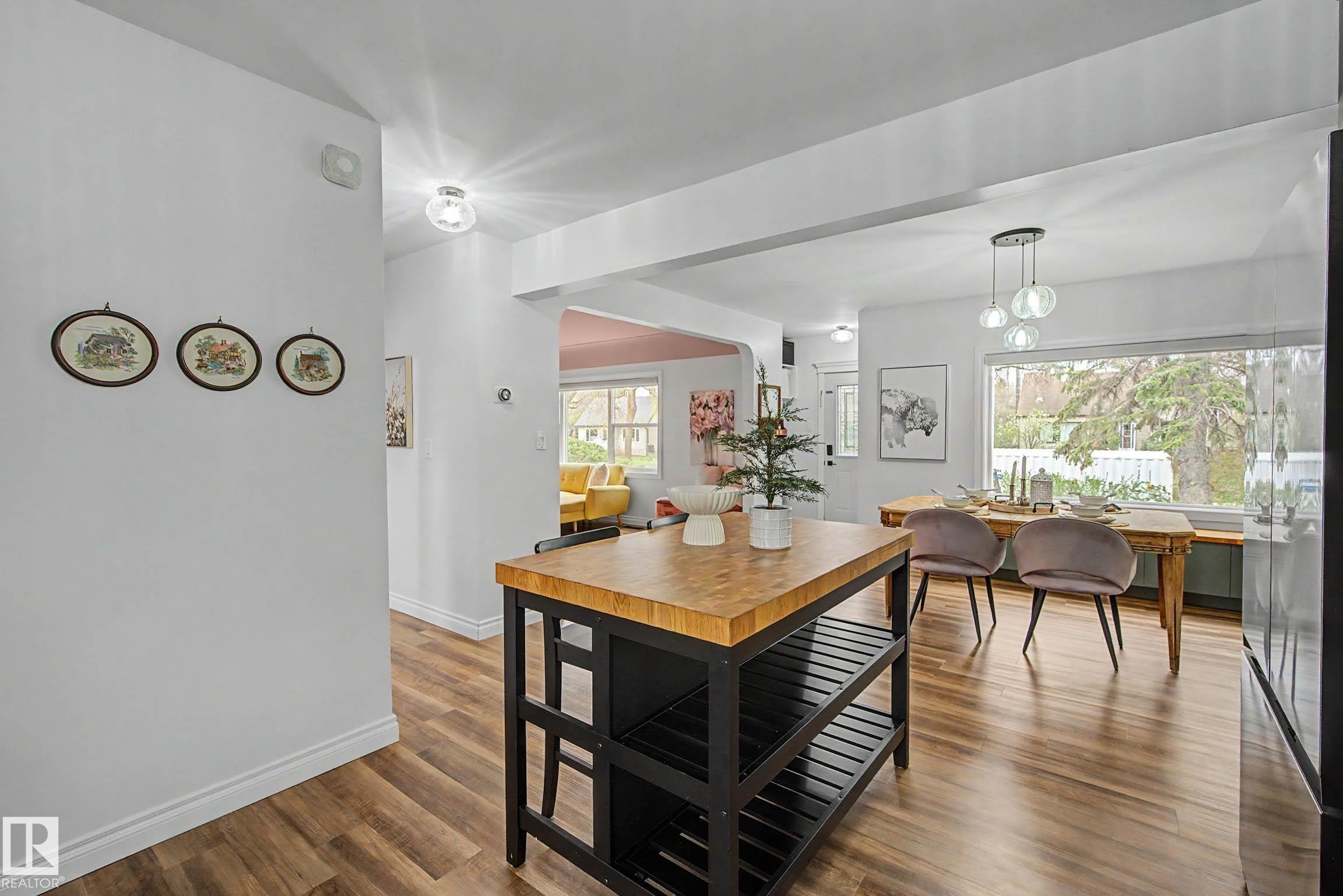 Kitchen island with butcher block countertop and black shelving - 13316 109A Avenue, Edmonton, AB - Indoor