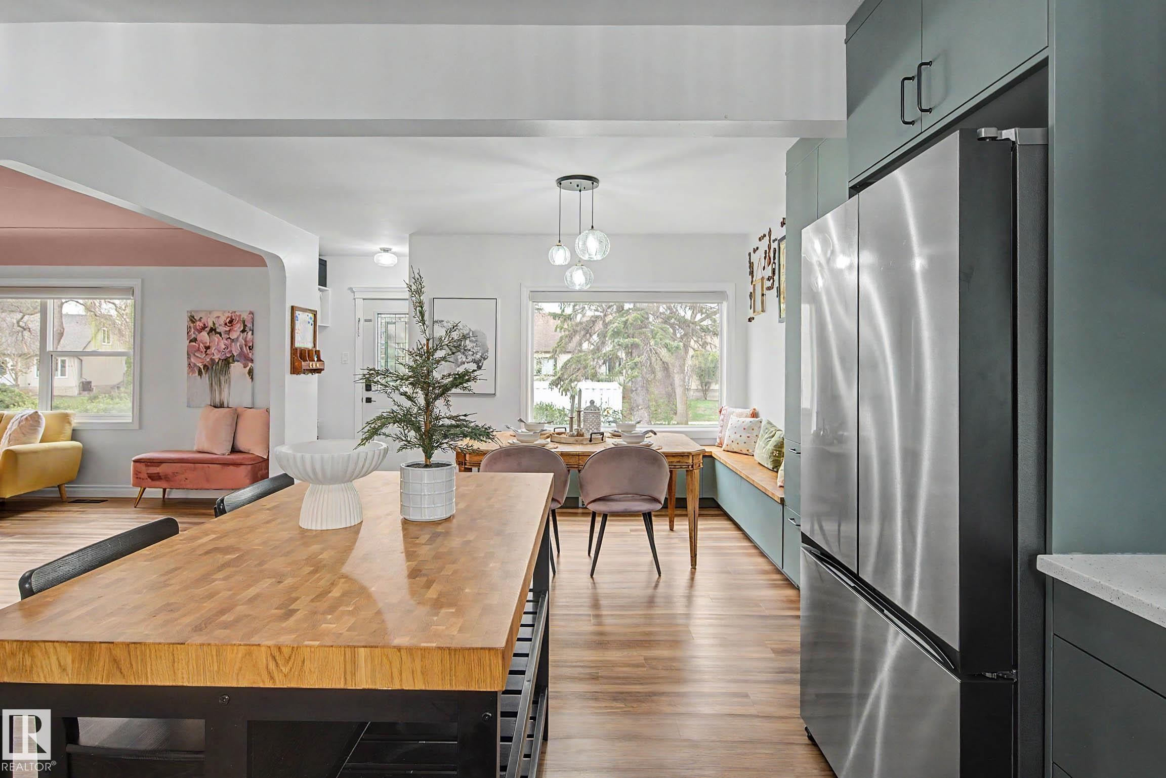 Open-concept living space with wood-finish flooring - 13316 109A Avenue, Edmonton, AB - Indoor