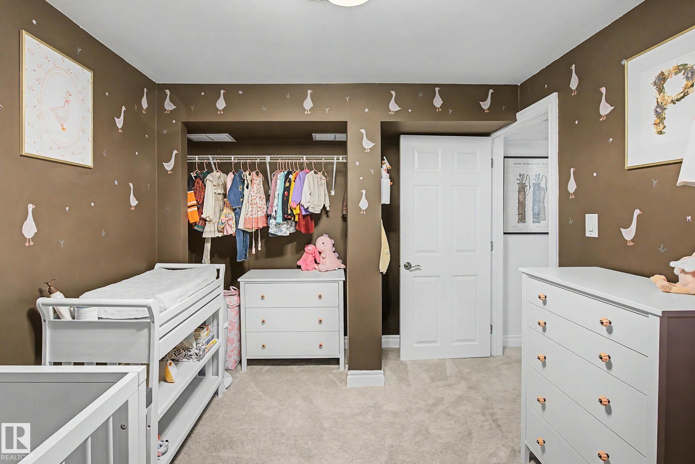 Recessed closet with integrated shelving and hanging rods - 13316 109A Avenue, Edmonton, AB - Indoor