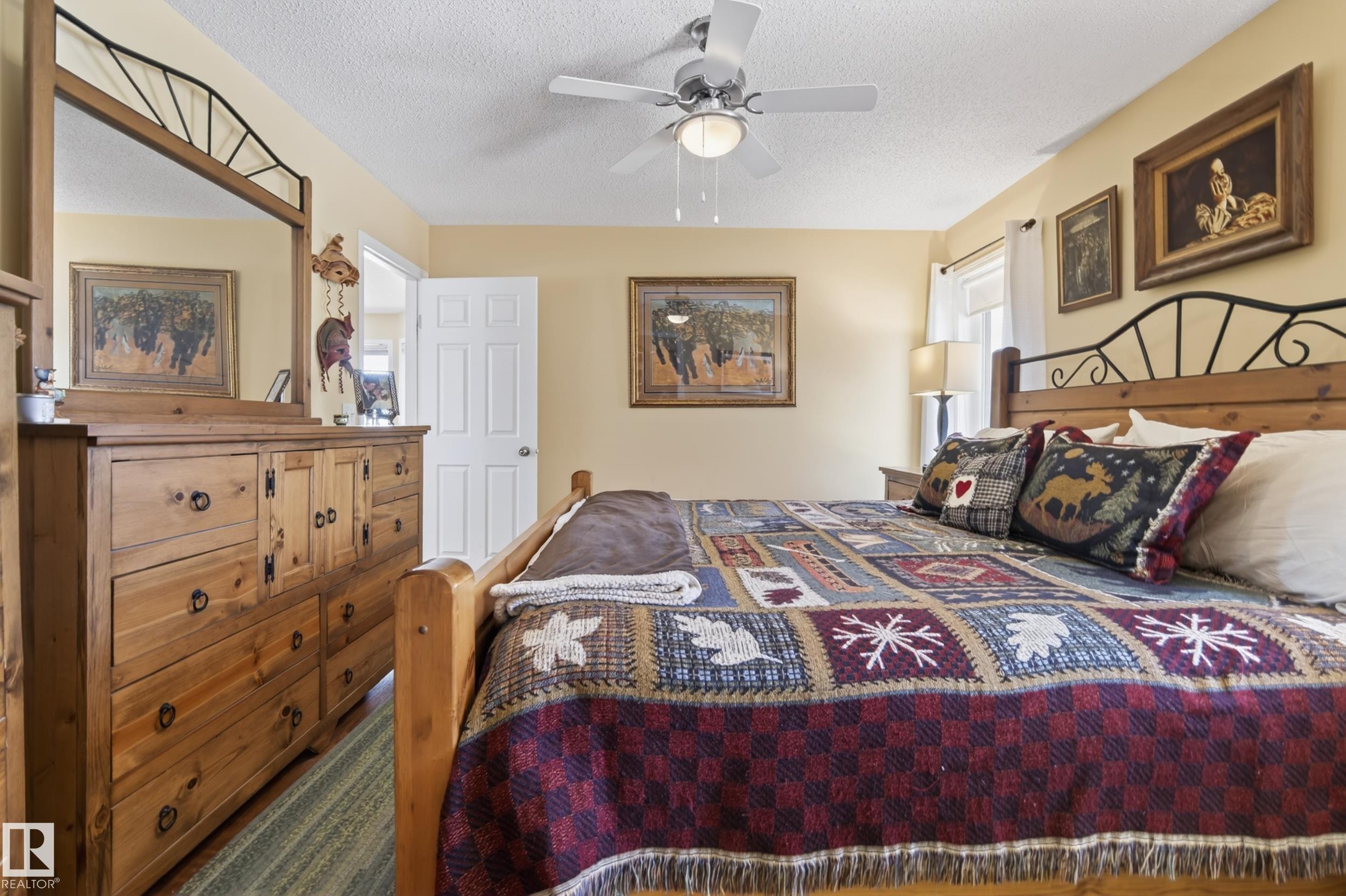 Bedroom with light yellow walls and a textured ceiling - 77 Lakeshore Drive, Rural Leduc County, AB - Indoor Photo Showing Bedroom