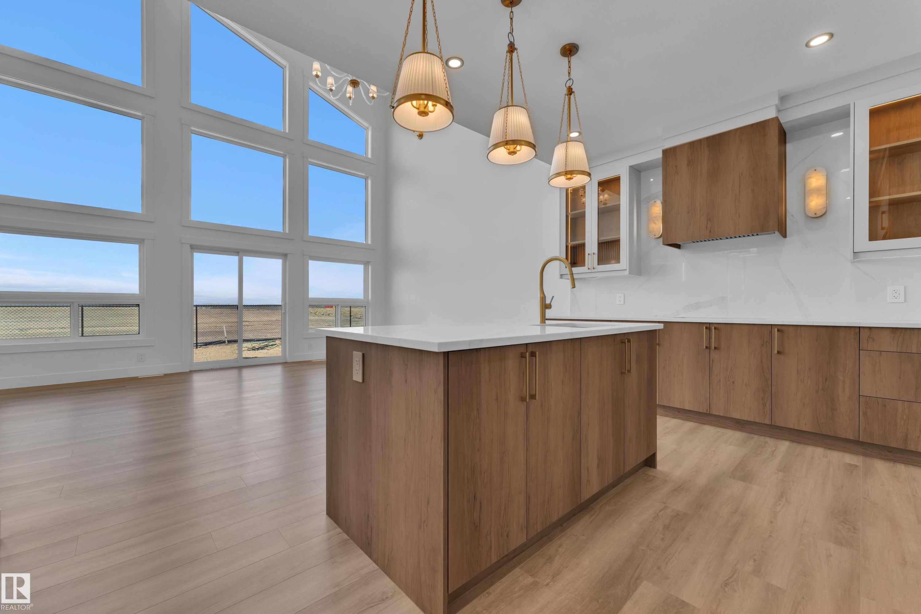 Open-concept kitchen and living area featuring a large central island with an integrated sink and gooseneck faucet - 13128 187 Avenue, Edmonton, AB - Indoor Photo Showing Kitchen