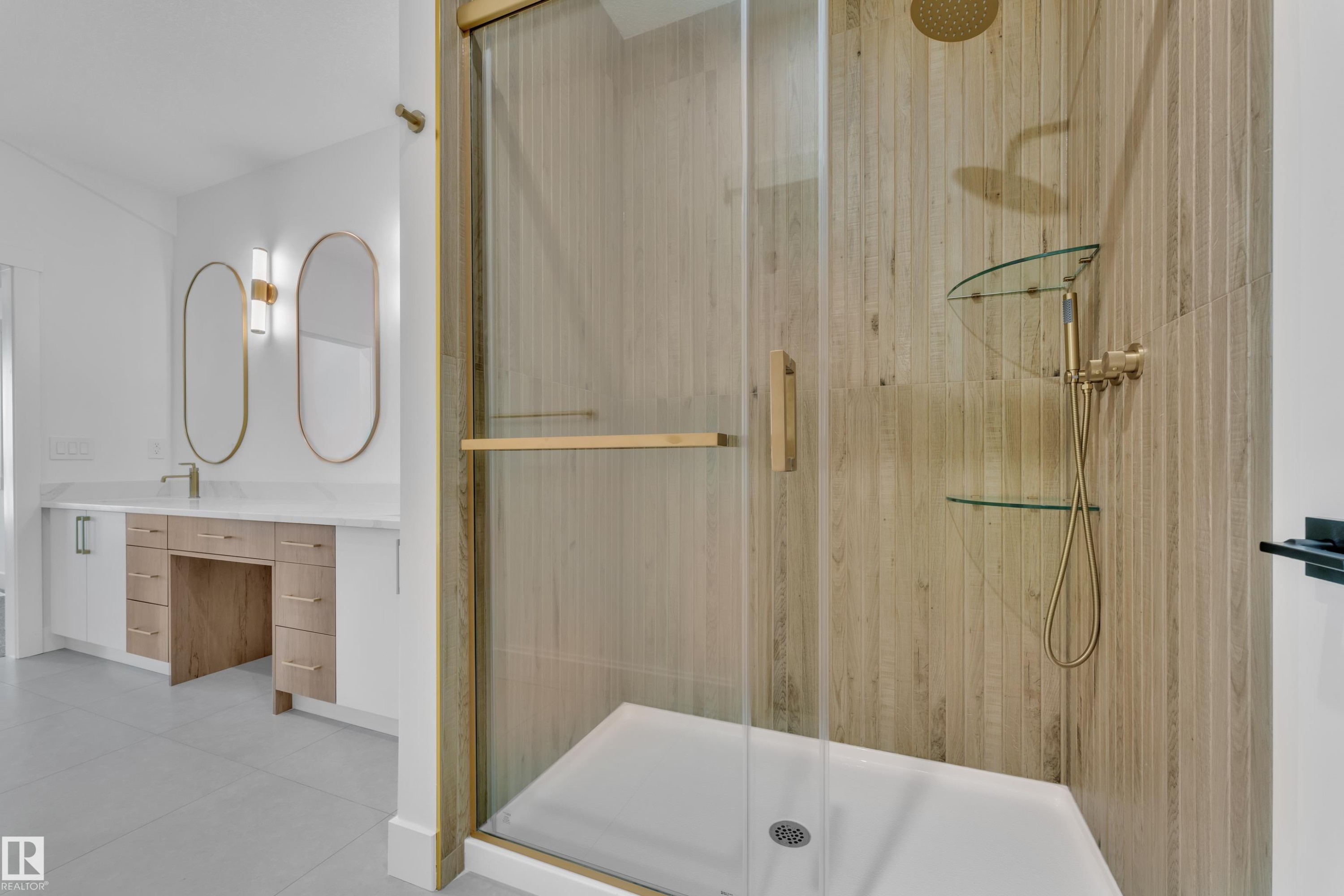 Glass-enclosed shower featuring a wood-look tiled wall and brass fixtures - 13128 187 Avenue, Edmonton, AB - Indoor Photo Showing Bathroom