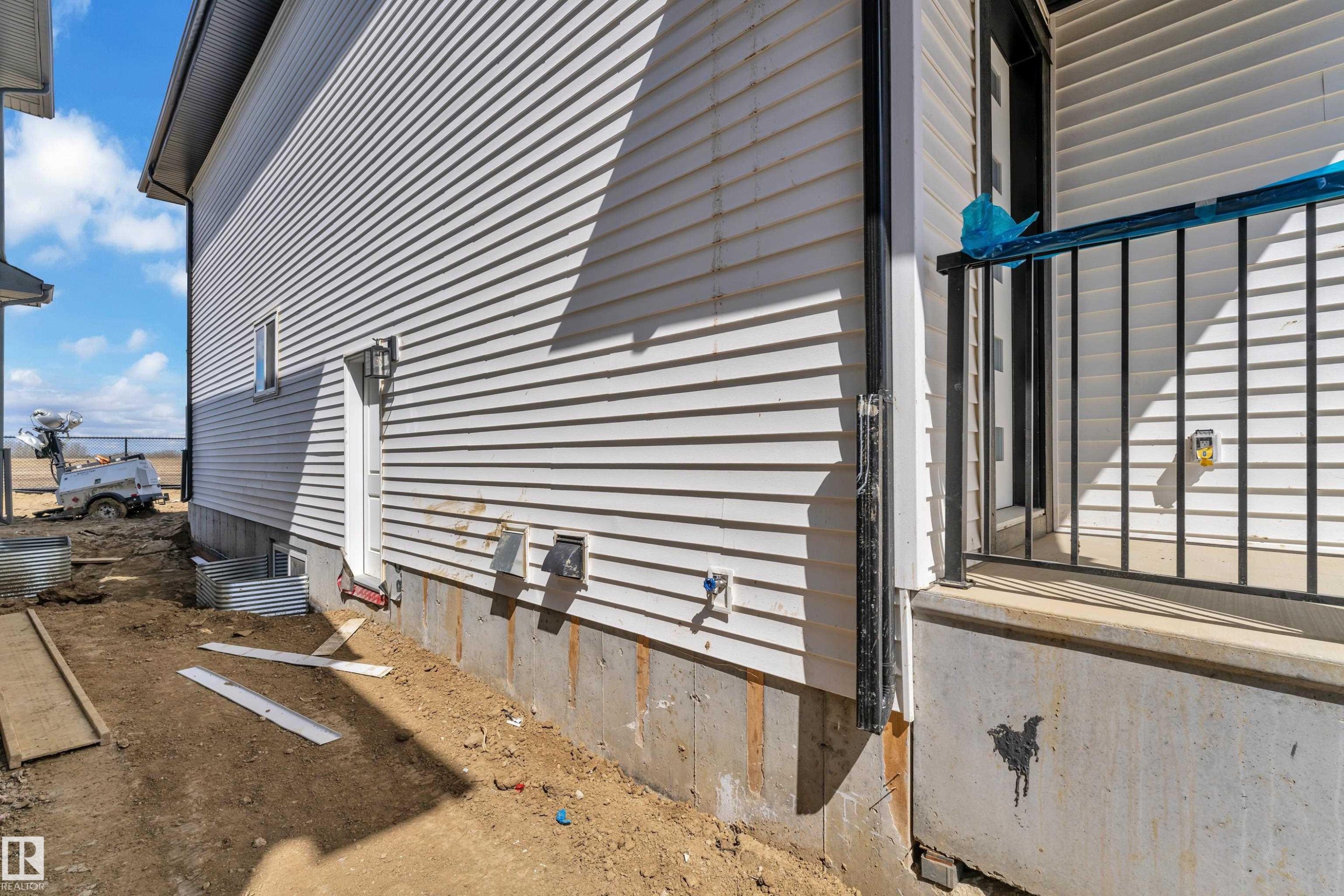 White horizontal siding exterior with a concrete foundation - 13128 187 Avenue, Edmonton, AB - Outdoor With Exterior
