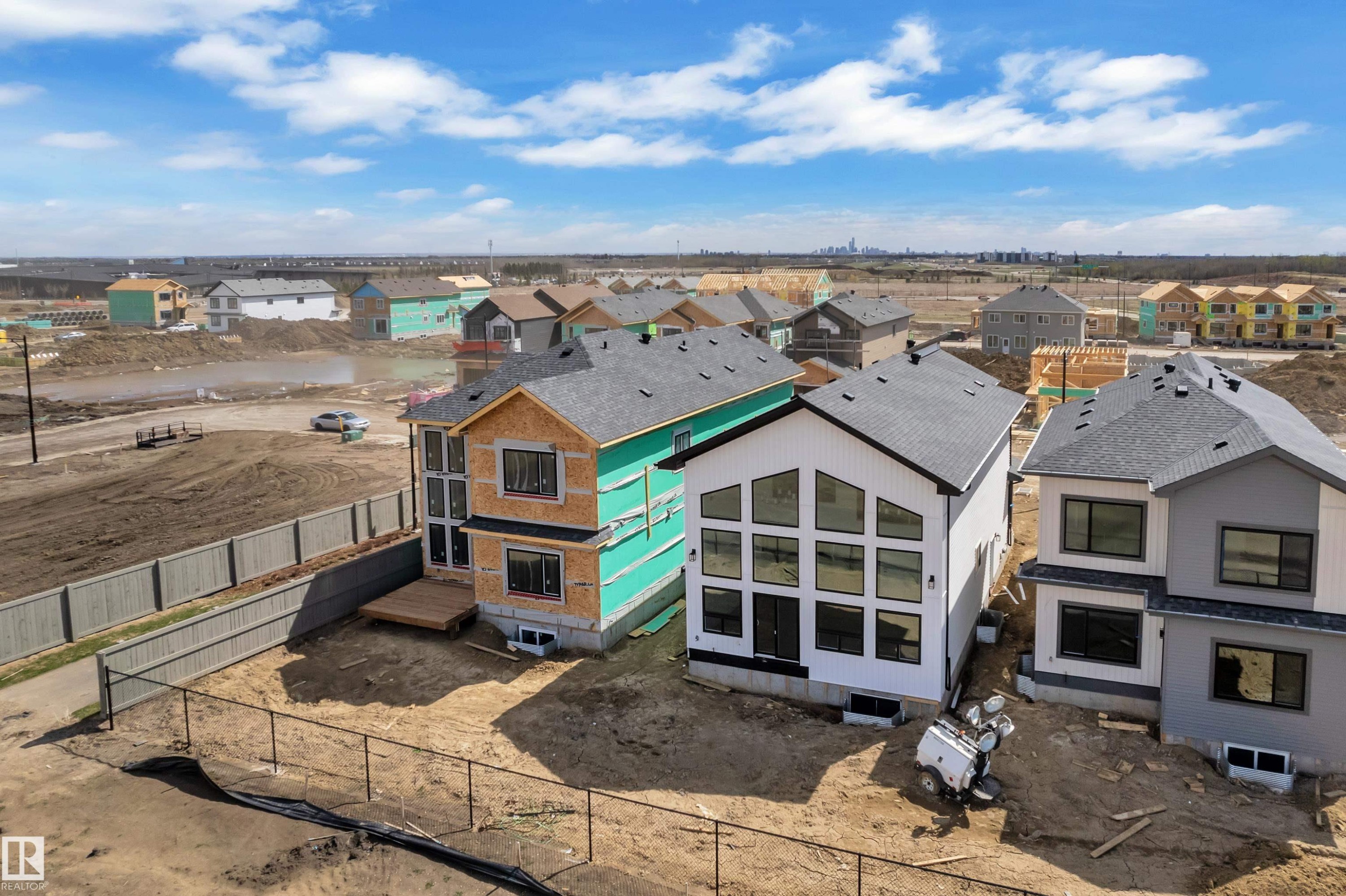 Modern new construction featuring a white exterior with black-framed windows, a distinctive window wall, and a dark shingle roof - 13128 187 Avenue, Edmonton, AB - Outdoor With View