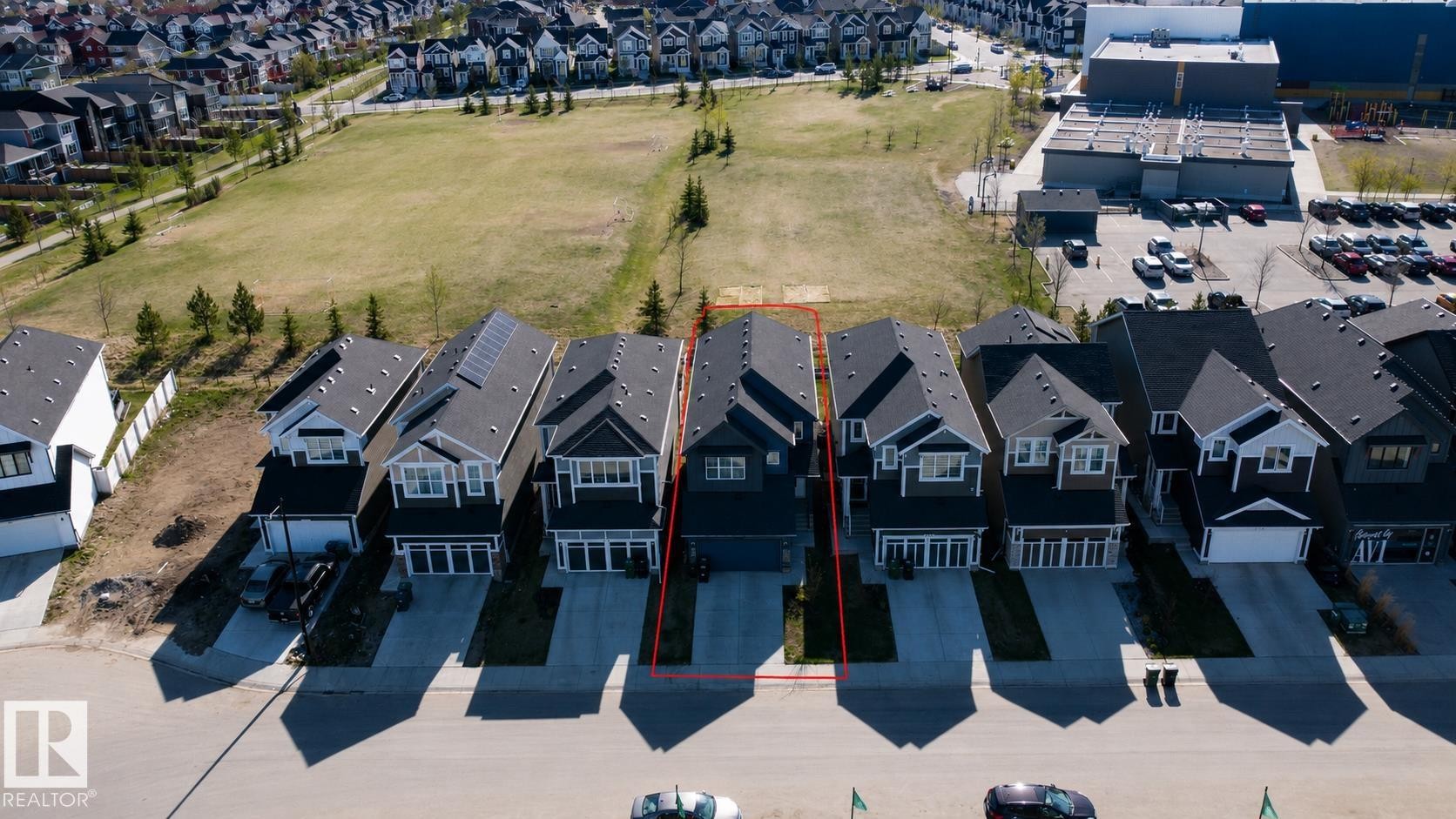 Modern two-story residence with a dark facade and white trim - 121 Stiles Bend, Leduc, AB -