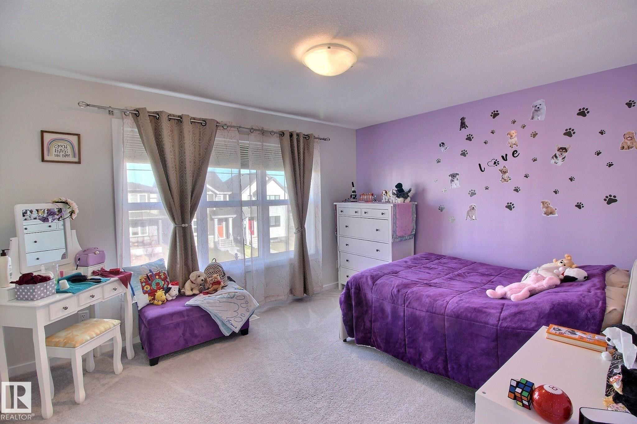 Spacious room featuring broad windows with dual curtain rods, a ceiling-mounted light fixture, and plush carpeting - 121 Stiles Bend, Leduc, AB - Indoor Photo Showing Bedroom