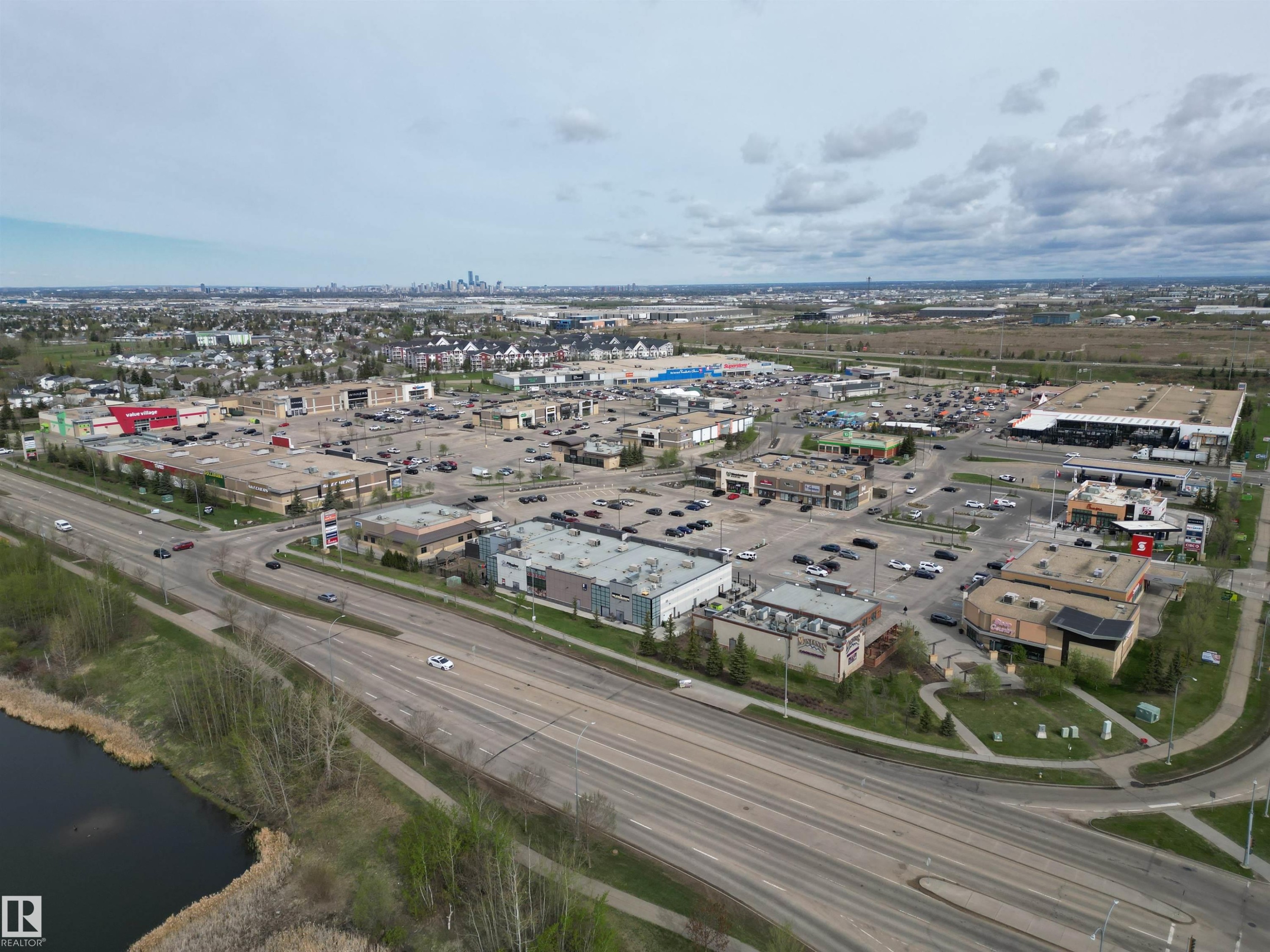 Expansive commercial development featuring multiple retail buildings and extensive parking areas - 645 Windross Crescent, Edmonton, AB