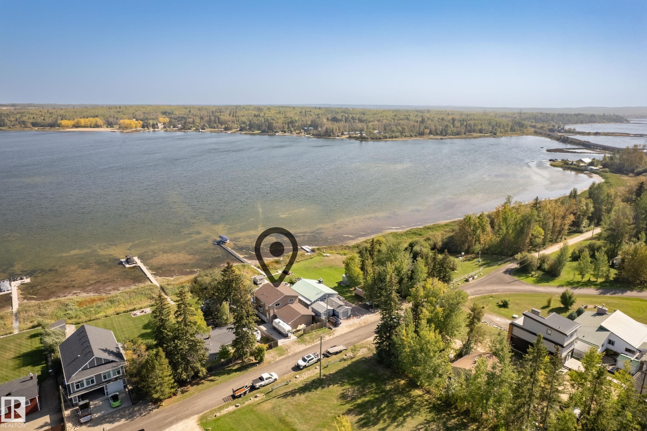Waterfront property featuring a private dock and direct lake access - 104 Bayview Drive, Rural Parkland County, AB