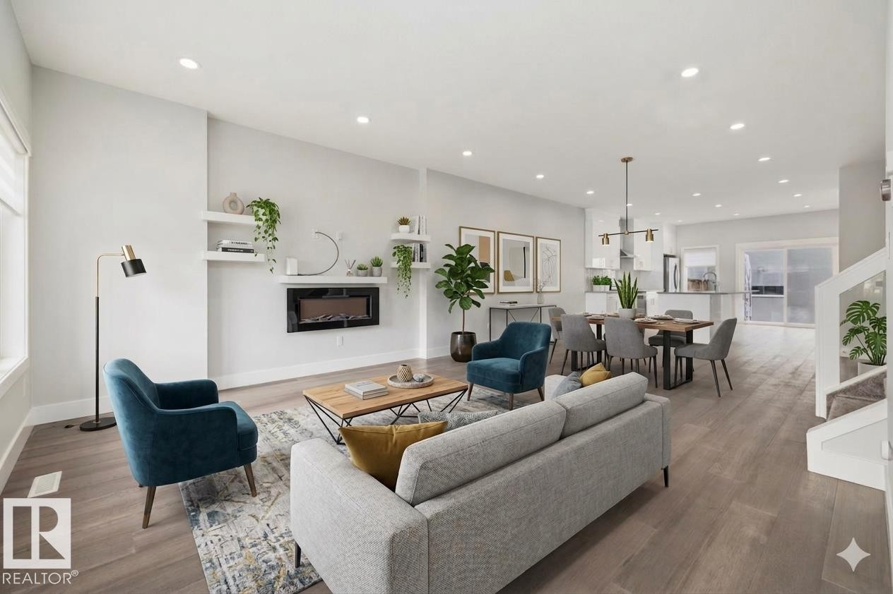 Open-concept living space featuring wood-finish flooring, recessed lighting, and a modern wall-mounted fireplace - 9933 79 Street, Edmonton, AB - Indoor Photo Showing Living Room With Fireplace