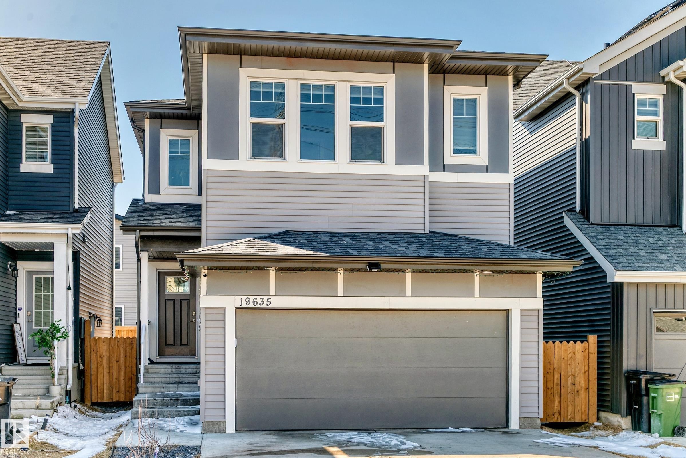 Contemporary two-story residence featuring a gray exterior with horizontal siding and vertical panel accents - 19635 29 Avenue, Edmonton, AB - Outdoor With Facade
