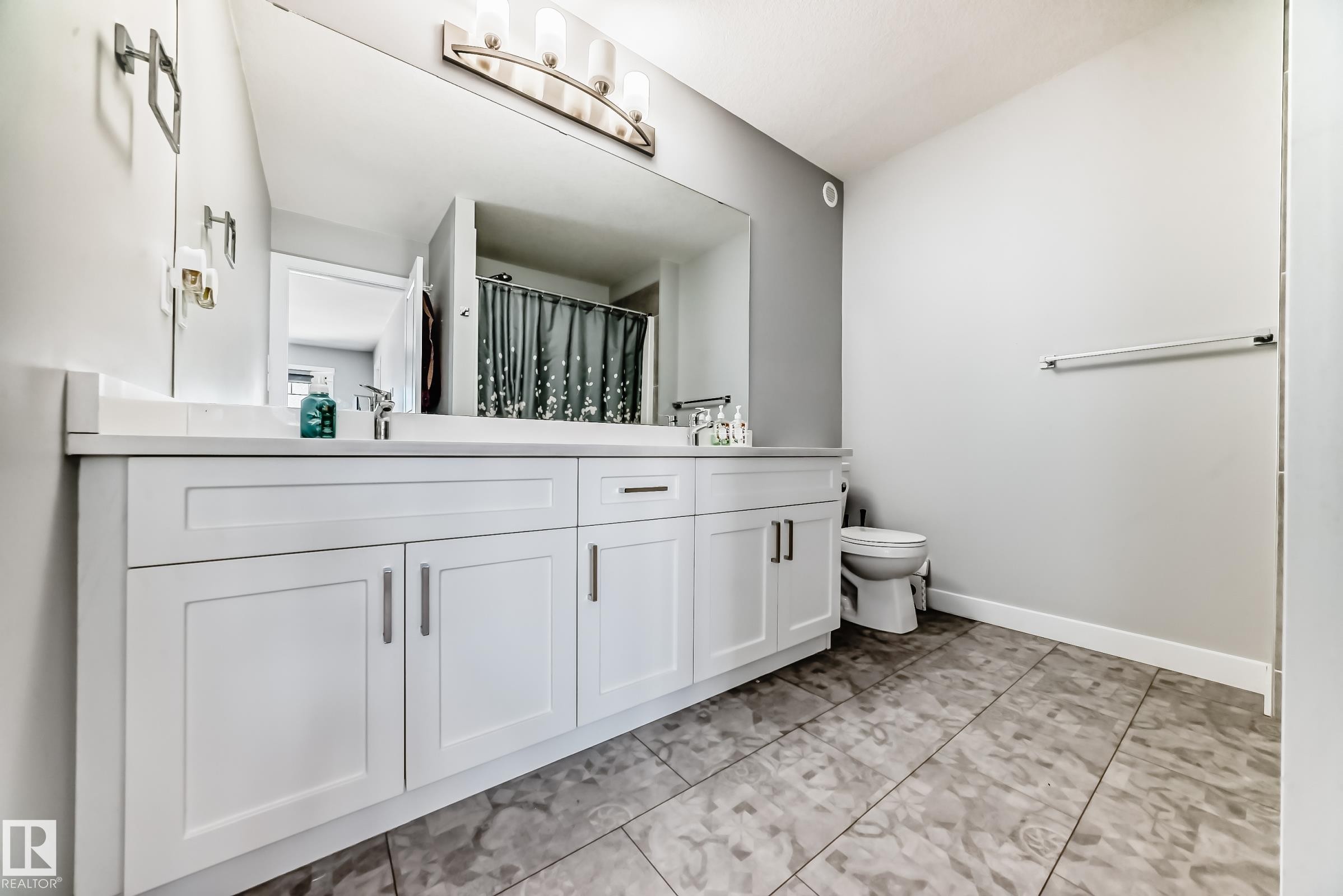 Dual-sink vanity with white cabinetry and integrated countertop - 19635 29 Avenue, Edmonton, AB - Indoor Photo Showing Bathroom