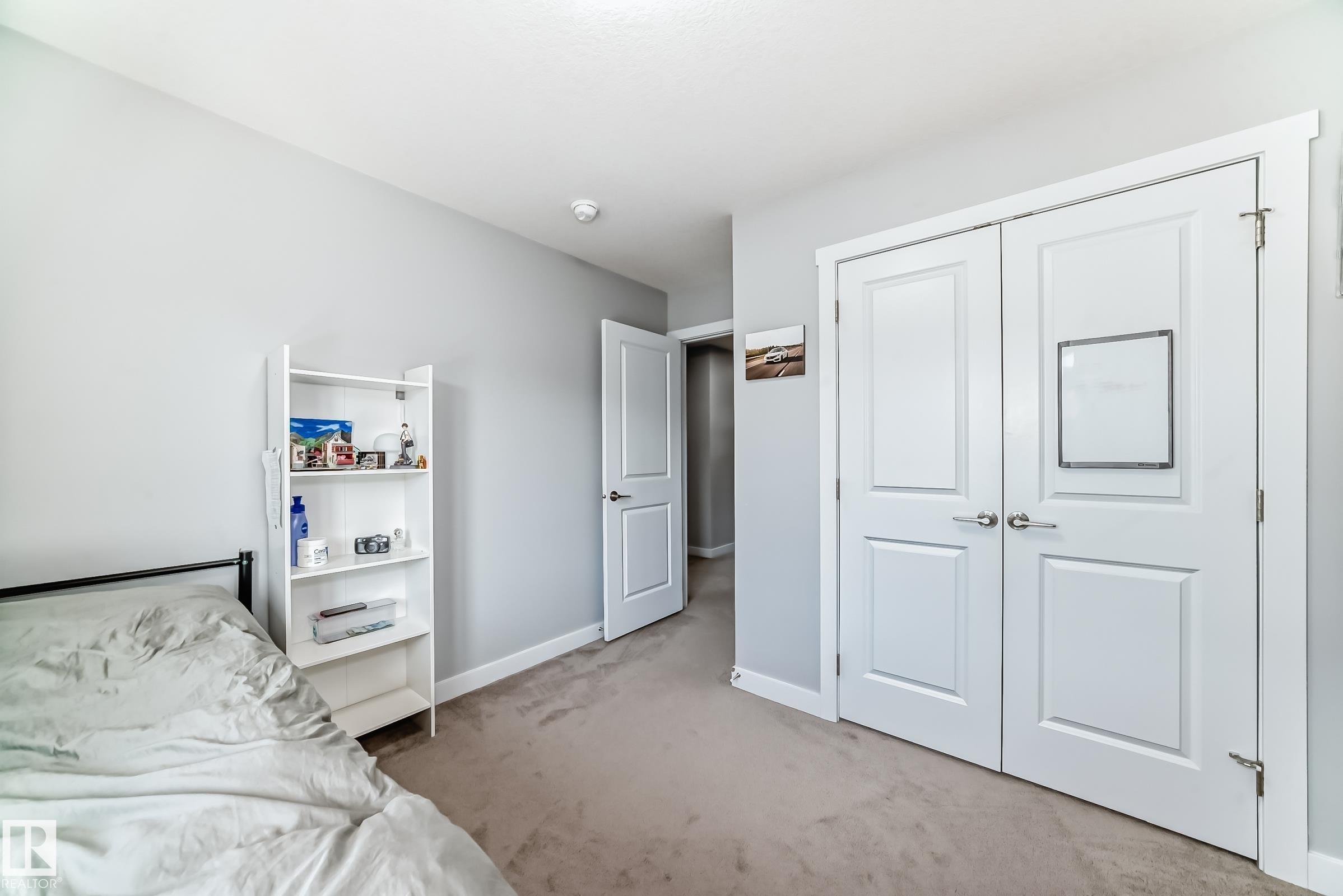 Light gray walls and neutral carpet flooring create a serene interior - 19635 29 Avenue, Edmonton, AB - Indoor Photo Showing Bedroom