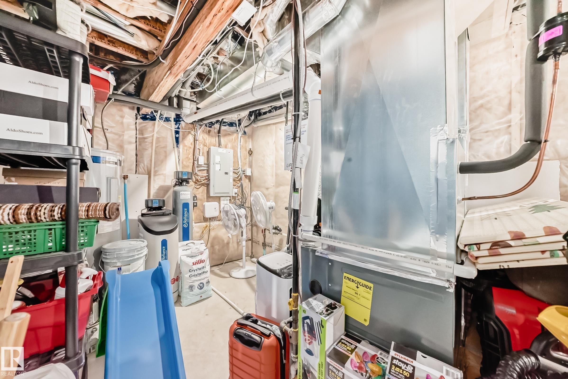 Basement utility area featuring a forced-air furnace, exposed wood ceiling joists, wall insulation, a water softener system, and an electrical panel - 19635 29 Avenue, Edmonton, AB - Indoor Photo Showing Basement
