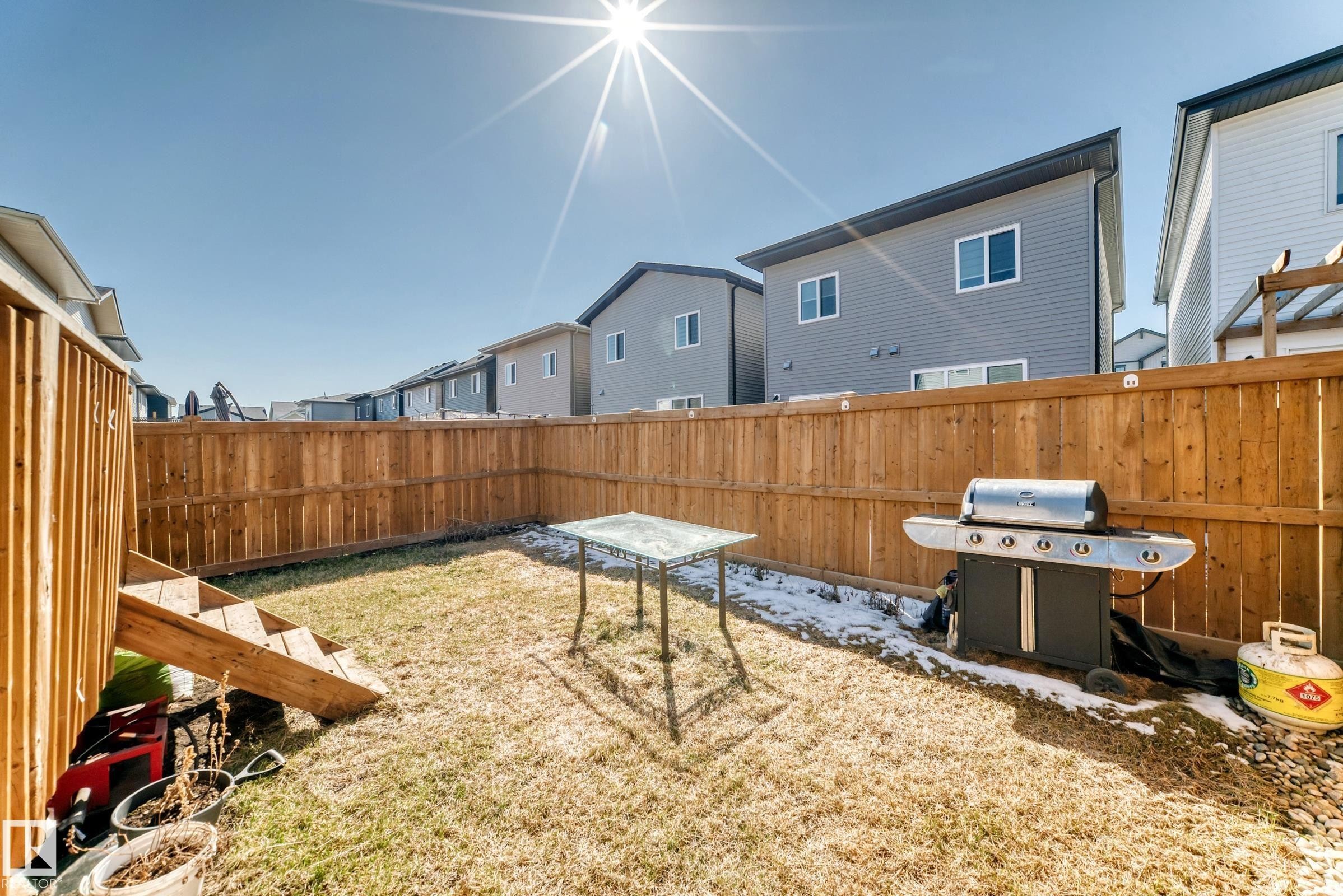Private fenced backyard with a wooden fence and grassy area - 19635 29 Avenue, Edmonton, AB - Outdoor