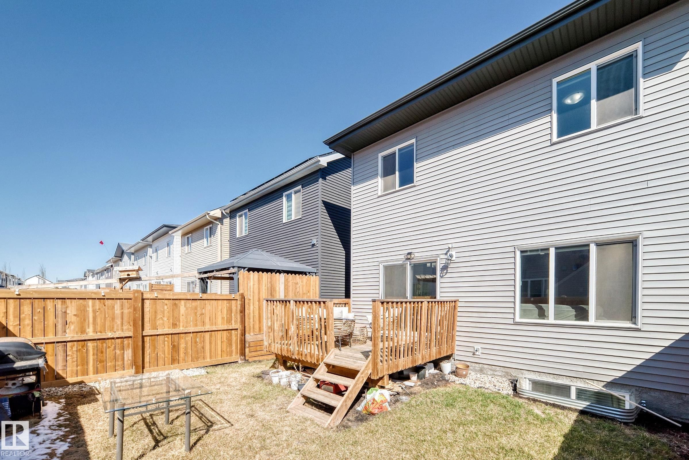Private backyard featuring a wooden privacy fence and a multi-level wooden deck - 19635 29 Avenue, Edmonton, AB - Outdoor With Exterior