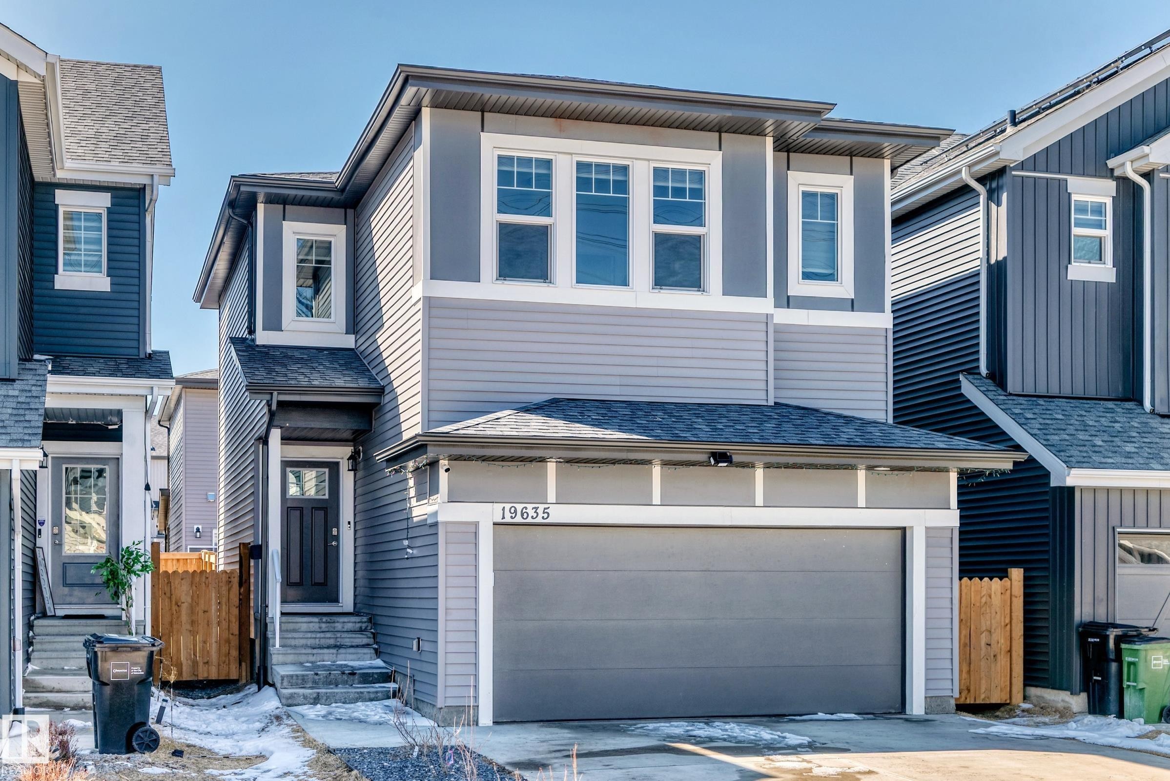 Modern two-story home featuring a two-tone gray facade with horizontal and vertical siding accents - 19635 29 Avenue, Edmonton, AB - Outdoor With Facade