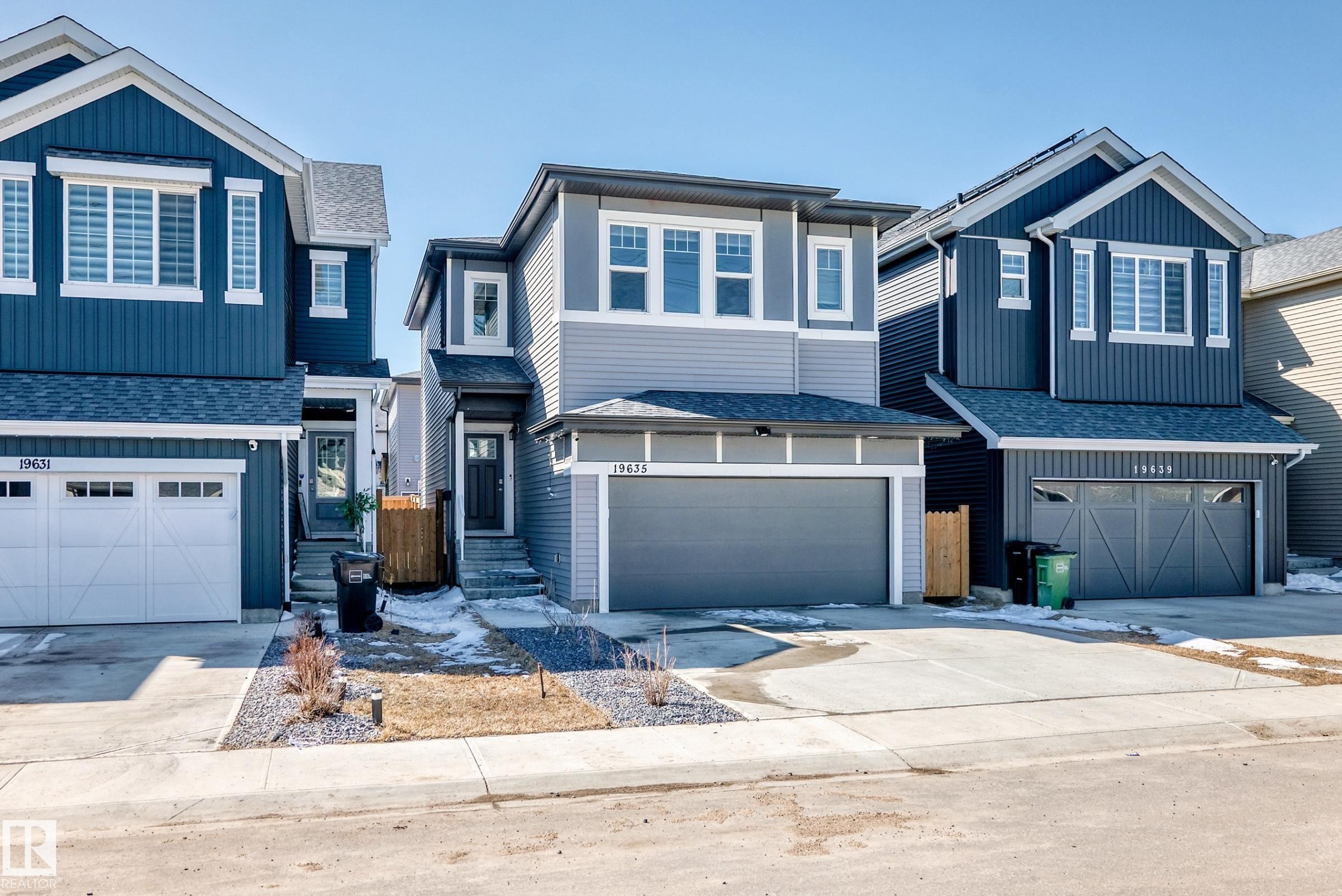 Modern two-story residence featuring light gray siding and dark gray trim accents - 19635 29 Avenue, Edmonton, AB - Outdoor With Facade