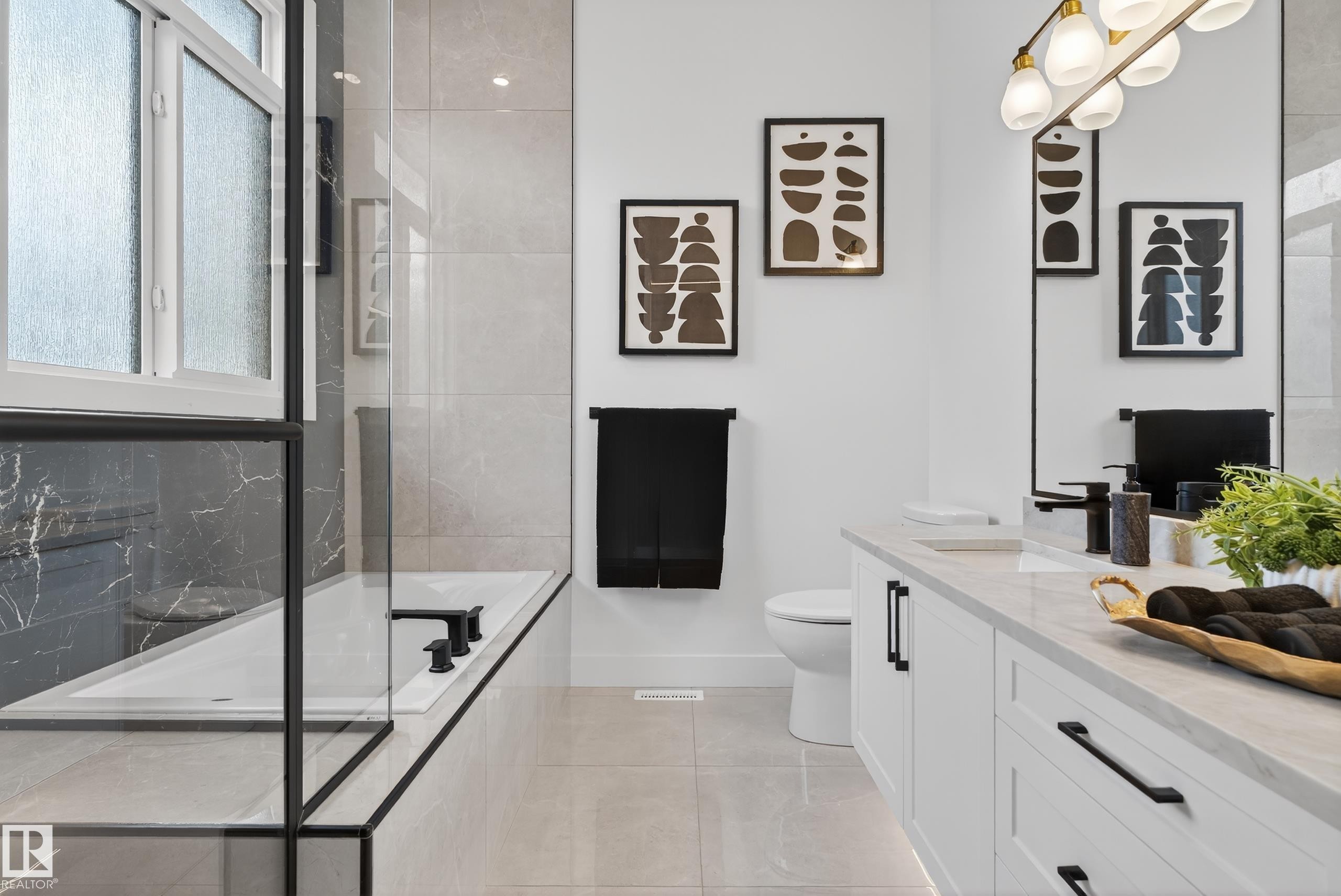Contemporary bathroom featuring a built-in tub with matte black fixtures, a clear glass shower enclosure, and grey tile flooring - 711 166 Avenue, Edmonton, AB - Indoor Photo Showing Bathroom
