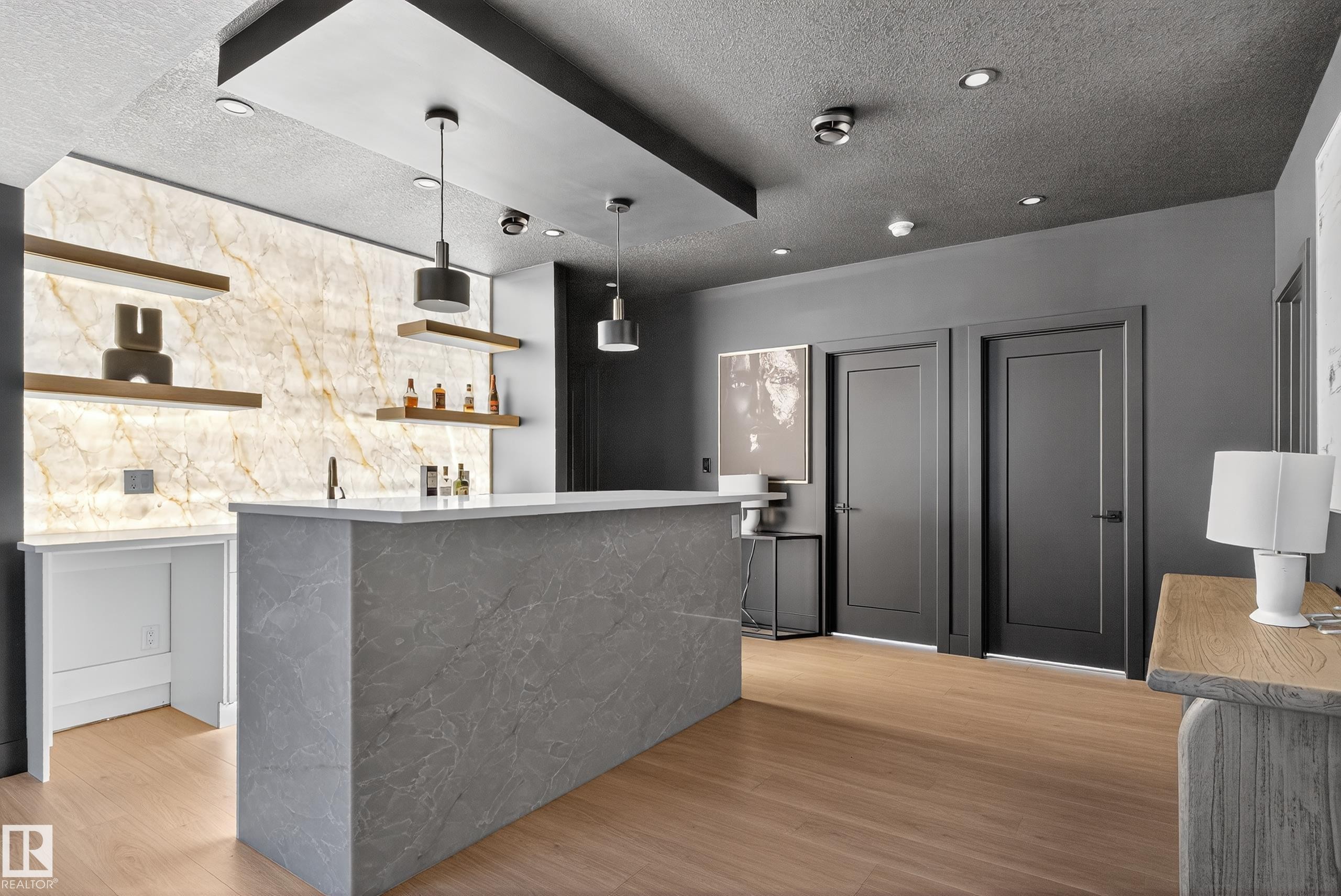 Custom bar area featuring a stone-finish countertop and a backlit stone wall - 711 166 Avenue, Edmonton, AB - Indoor Photo Showing Kitchen
