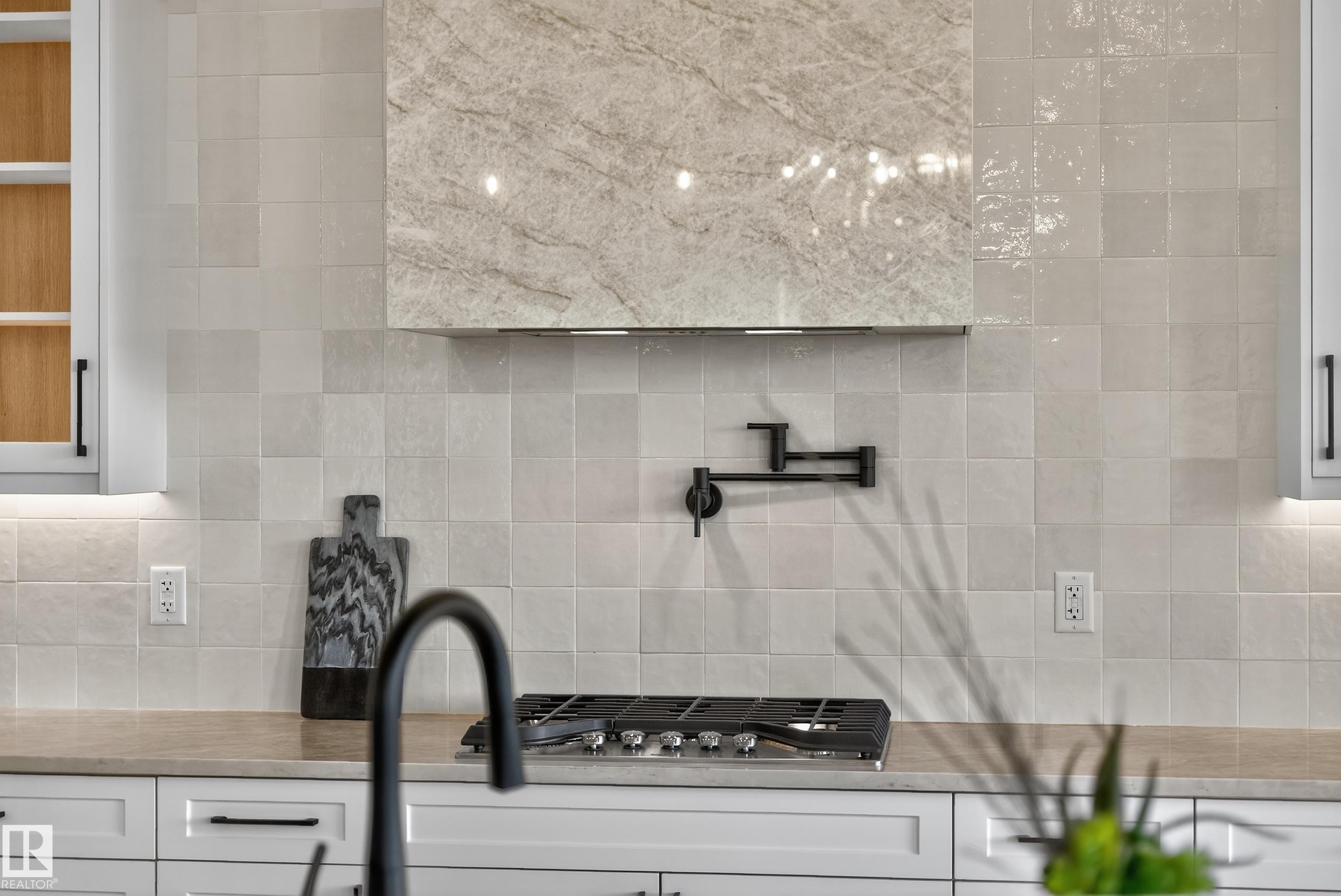 Kitchen featuring a gas range, pot filler, and custom range hood with stone-finish paneling - 711 166 Avenue, Edmonton, AB - Indoor Photo Showing Other Room